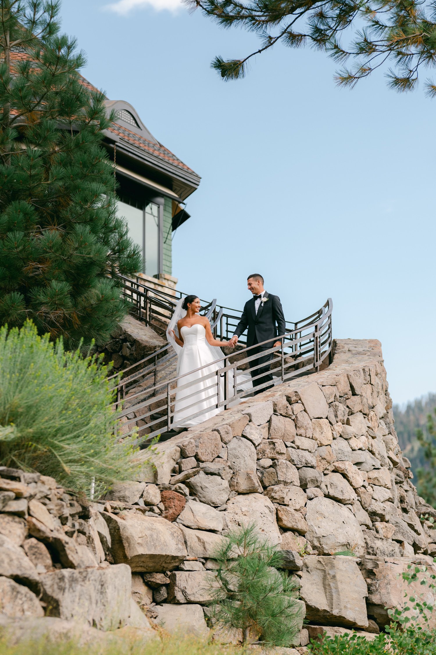 Martis Camp Wedding, photo of the couple holding hands while walking down the stairs