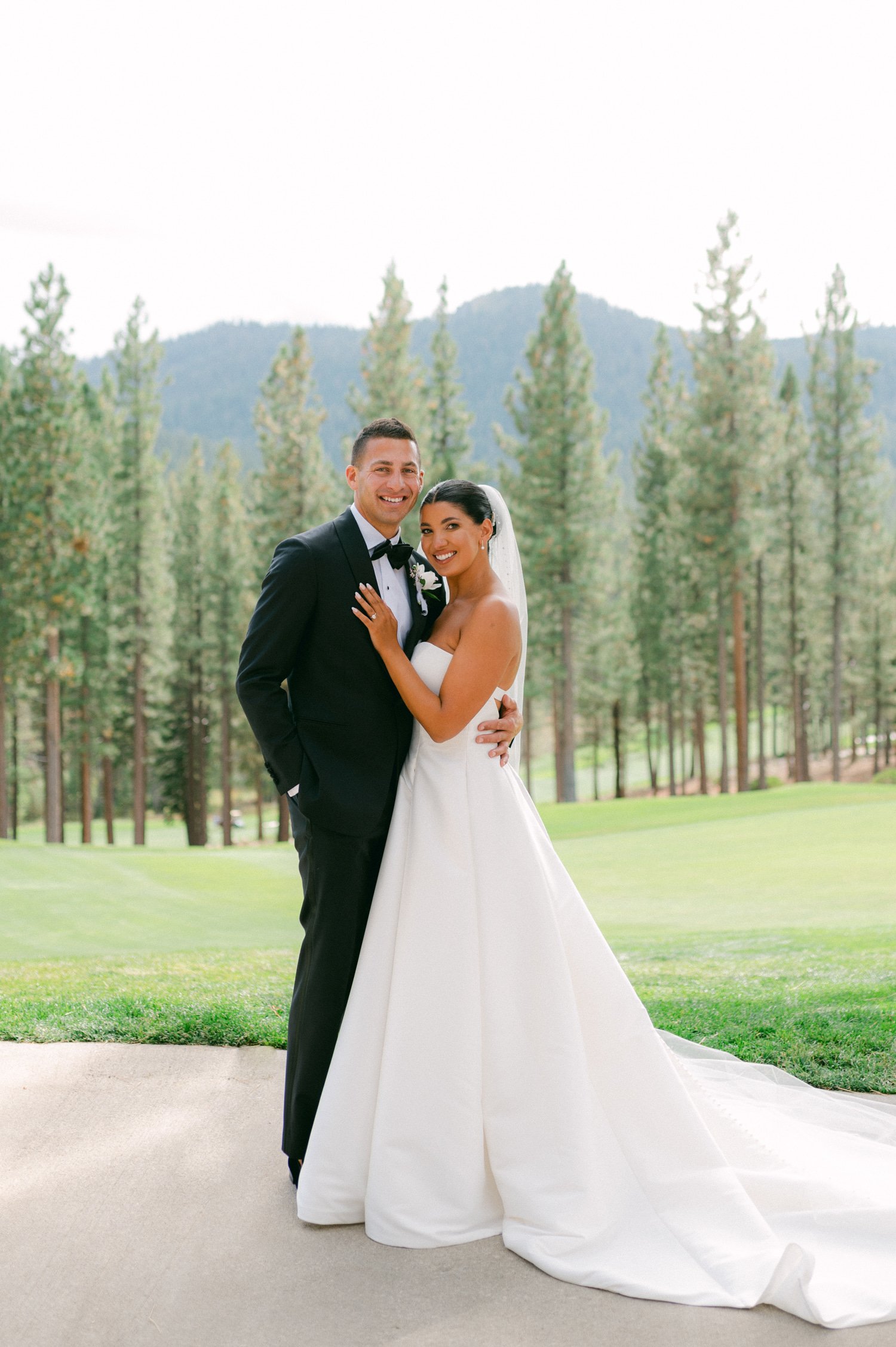 Martis Camp Wedding, photo of the groom in a suit and tie hugging the bride