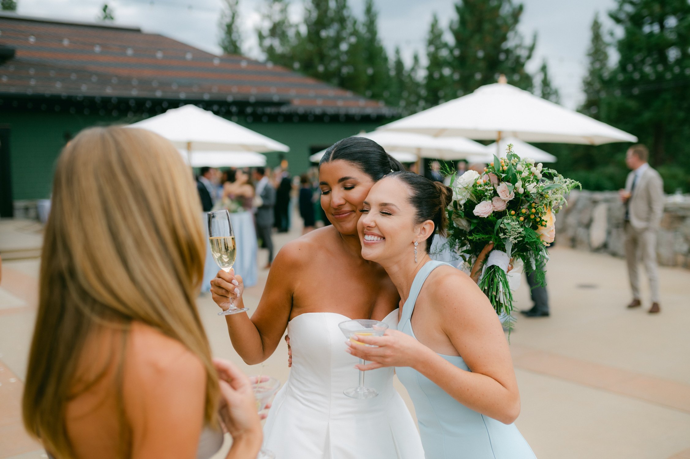 Martis Camp Wedding, photo of the bride hugging her guests during the afternoon reception