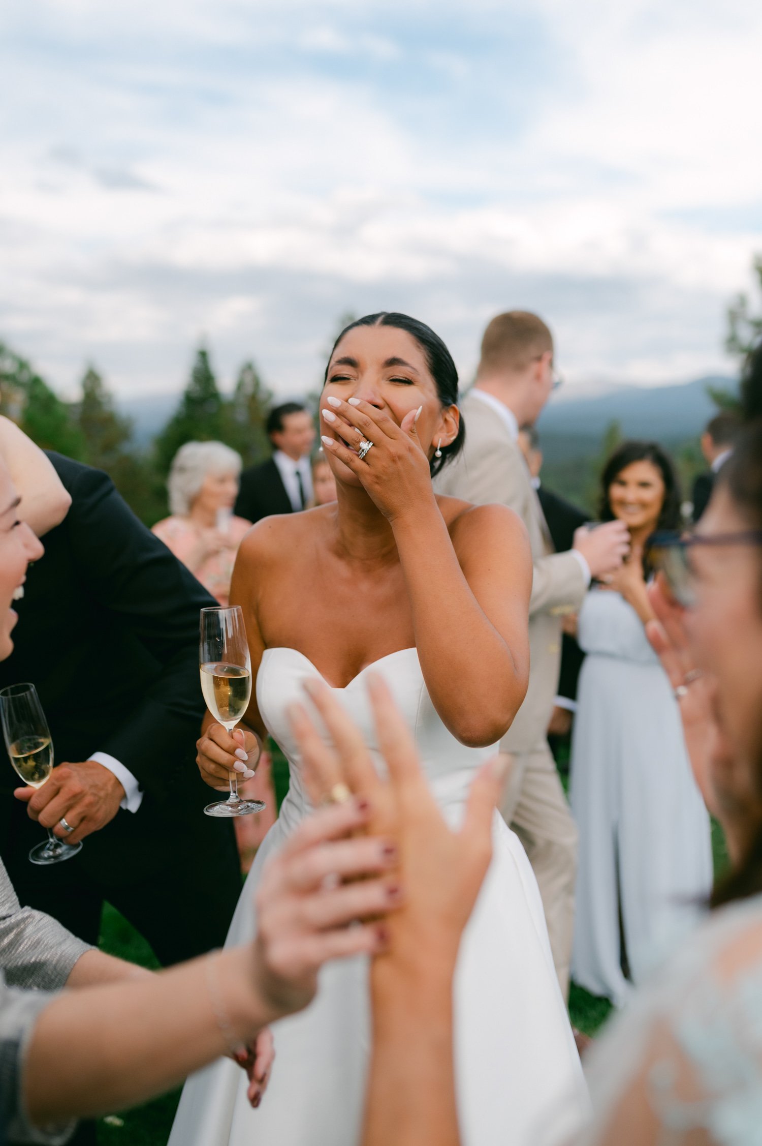 Martis Camp Wedding, photo of the bride laughing with her guests during the afternoon reception
