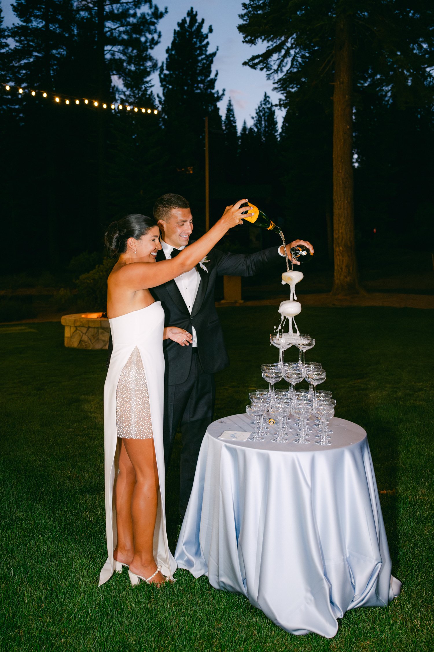 Martis Camp Wedding, photo of the newlywed couple pouring champagne on the glass tower