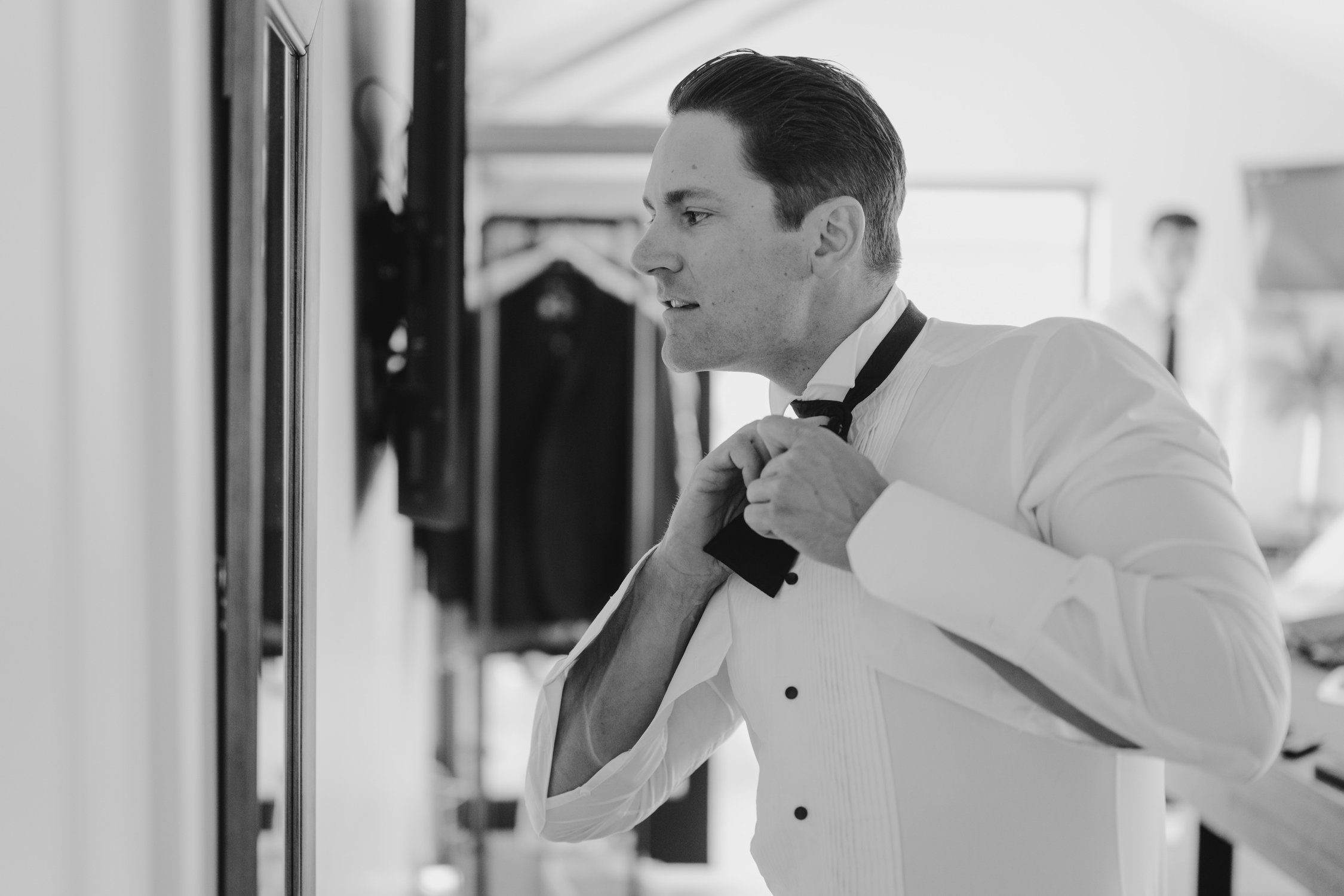 Elm Estate Wedding photos, photo of the groom tying his black bow tie in preparation for the his wedding day in Reno