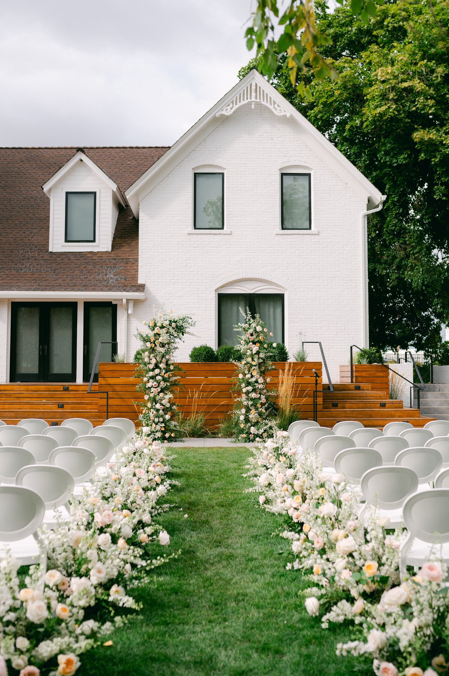 Elm Estate Wedding photos, photo of the wedding ceremony aisle filled with soft romantic colored flower arrangements 