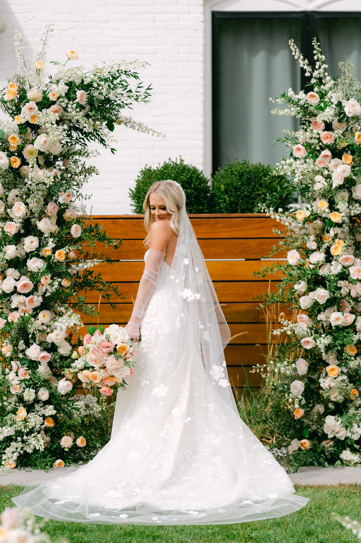 Elm Estate Wedding photos, photo of the bride's long ethereal wedding dress and veil surrounded by soft romantic florals