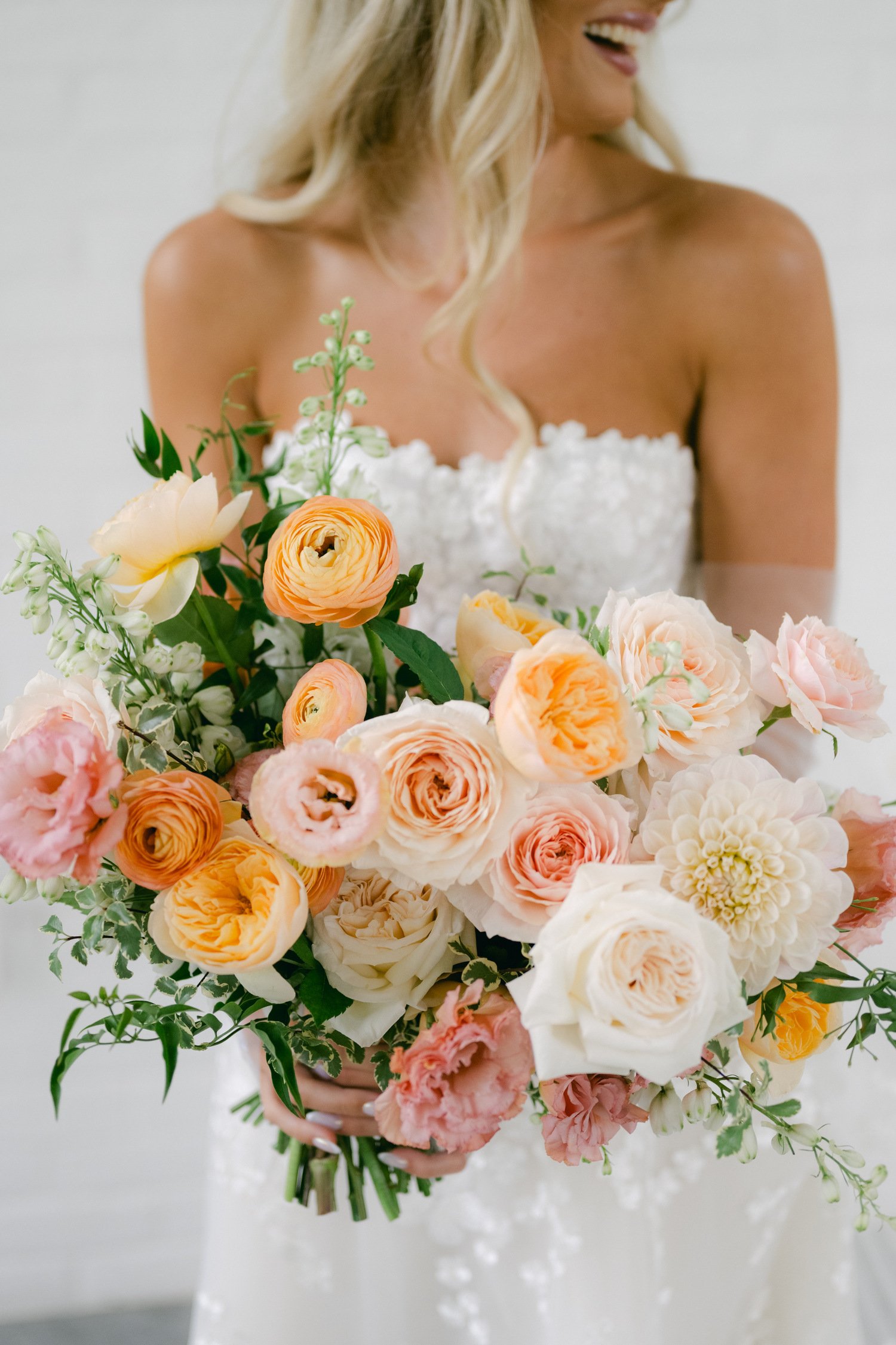 Elm Estate Wedding photos, photo of the bride's wedding bouquet with shades of pink and orange with white accents and greenery