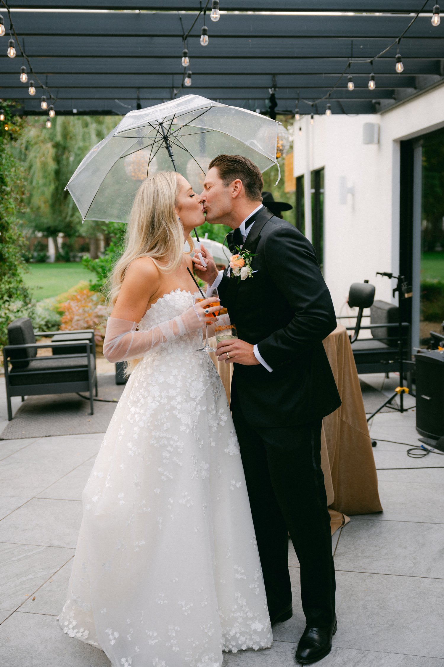 Elm Estate Wedding photos, photo of the newly wed couple kissing under a clear umbrella