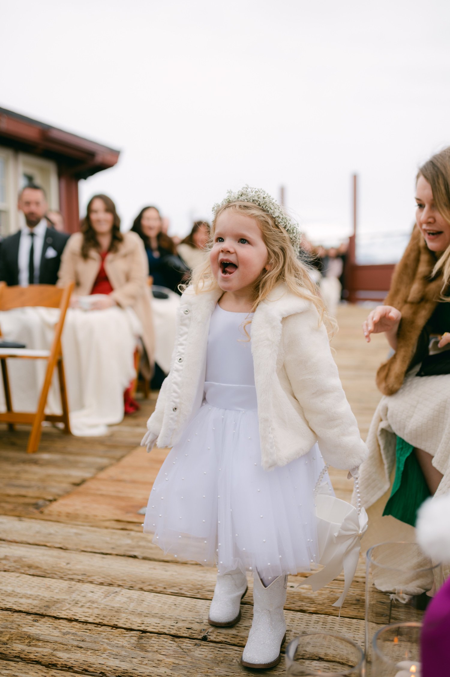 Sun Valley Roundhouse Wedding photos of the flower girl wearing a flower crown walking down the aisle