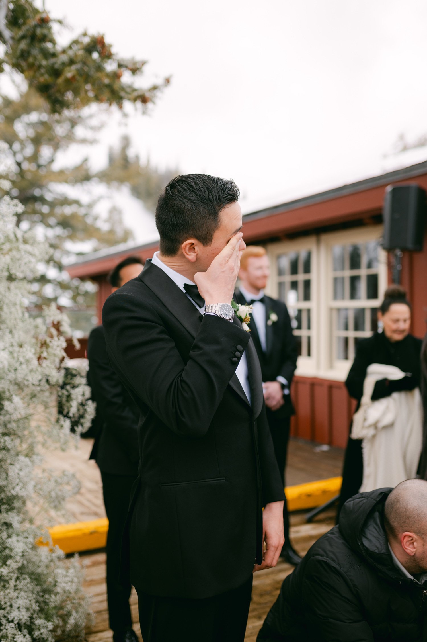 Sun Valley Roundhouse Wedding photos of the groom being emotional while the bride is walking down the aisle
