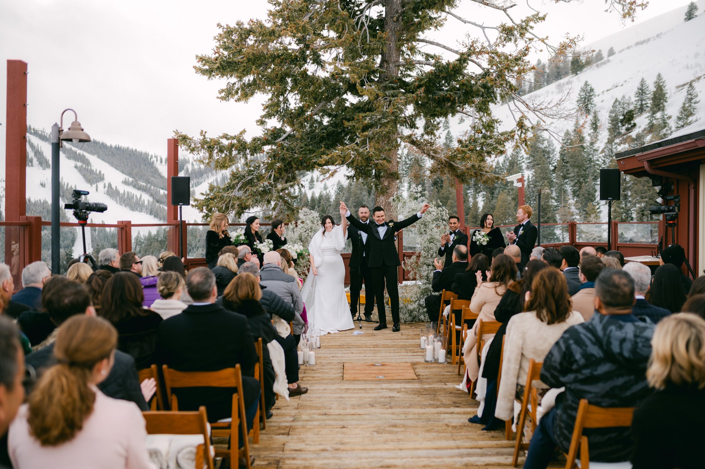 Sun Valley Roundhouse Wedding photo of the bride and groom happily raising their hand after their ceremony