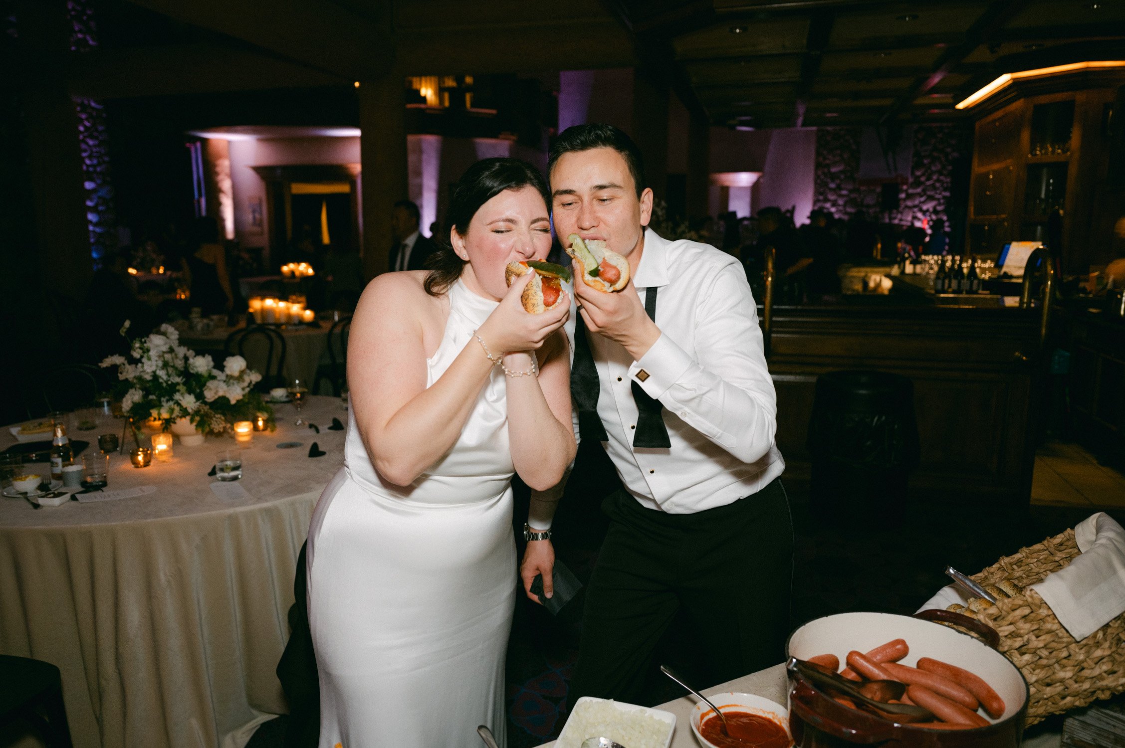 Sun Valley Roundhouse Wedding photo of the newlywed couple eating hotdog sandwich together