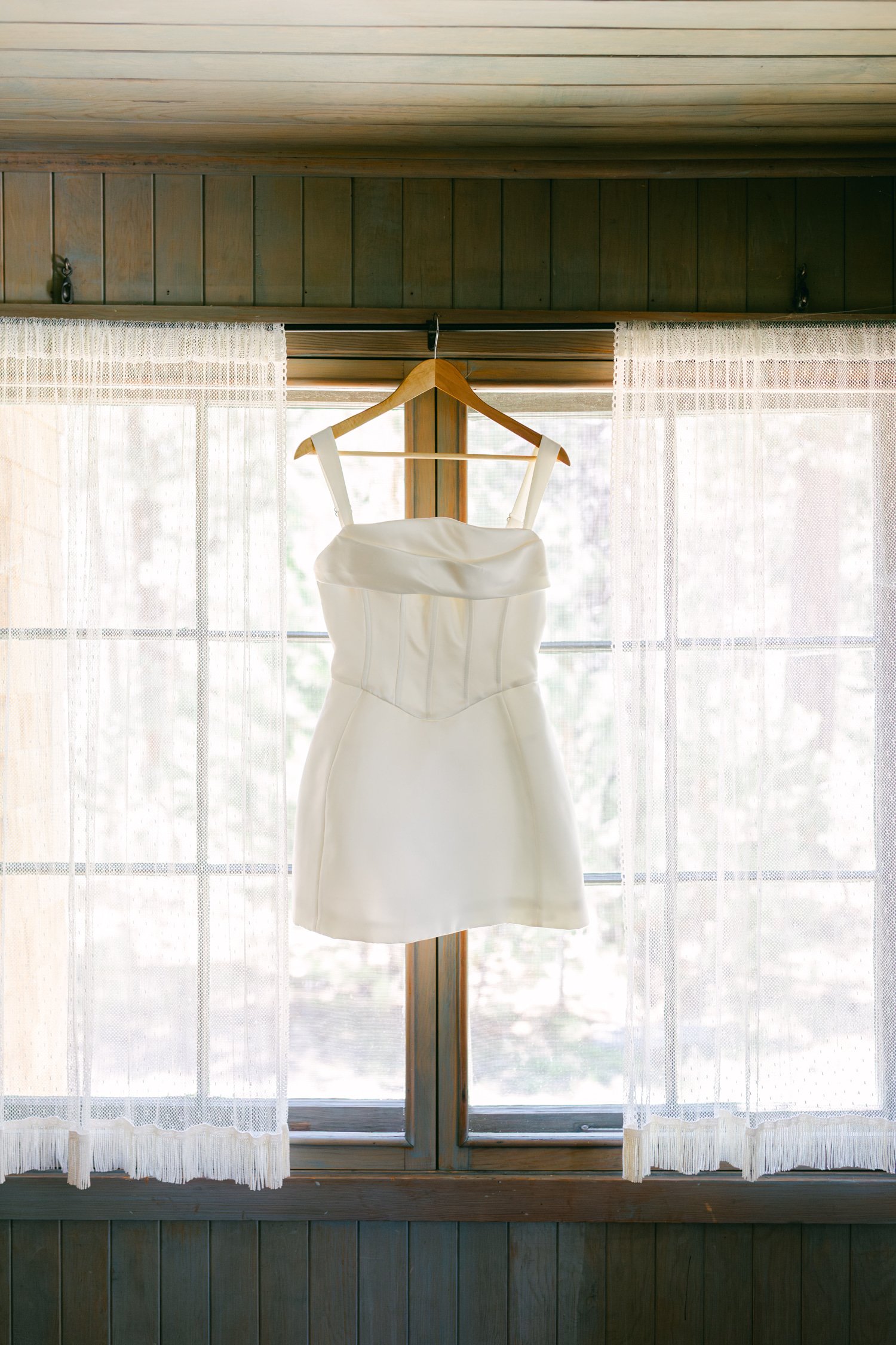 Valhalla wedding photo of the bride’s second dress hanging by the window