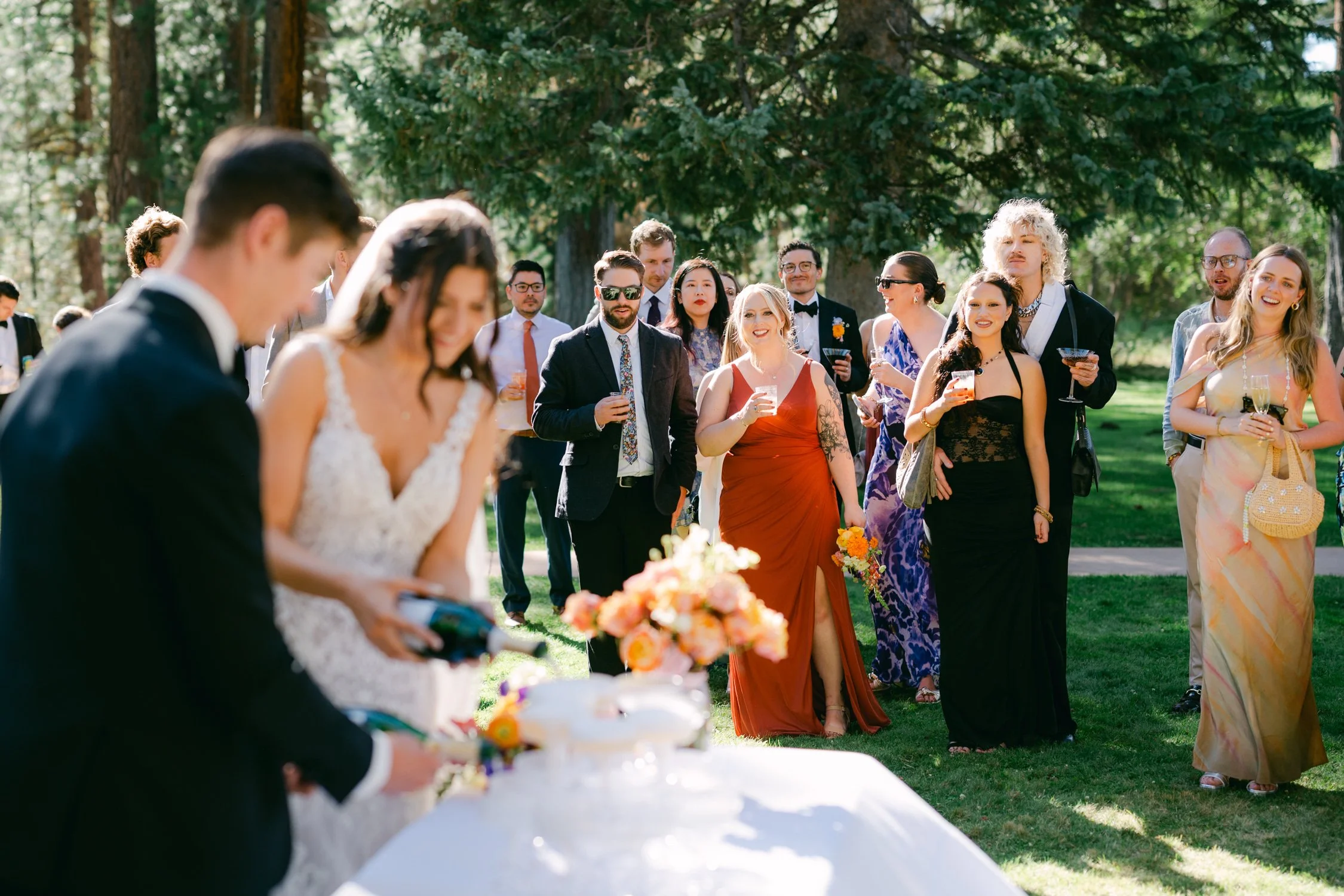 Valhalla wedding photo of the newlyweds cutting their cake surrounded by guests