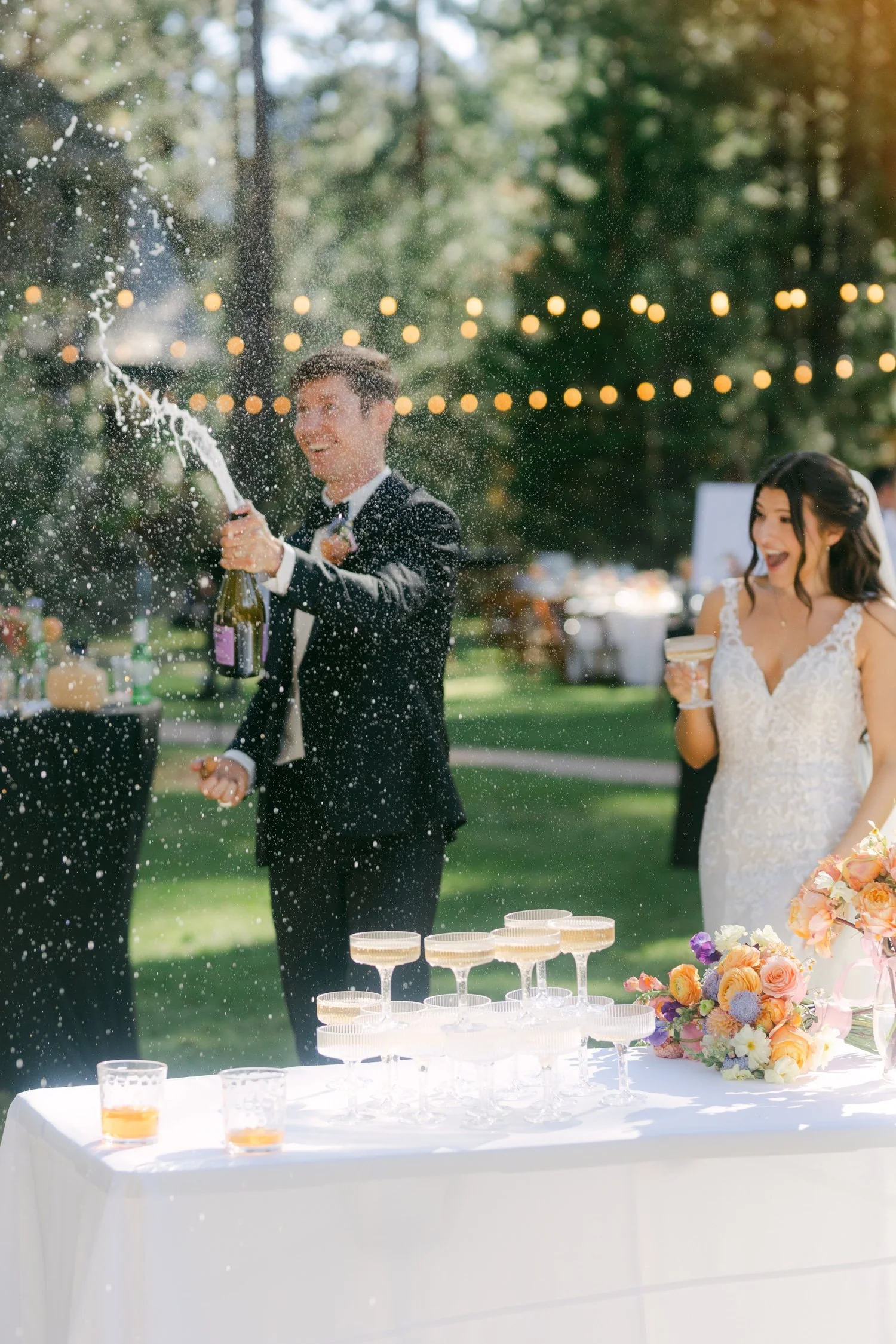 Valhalla wedding photo of the couple popping champagne in a fun shower moment