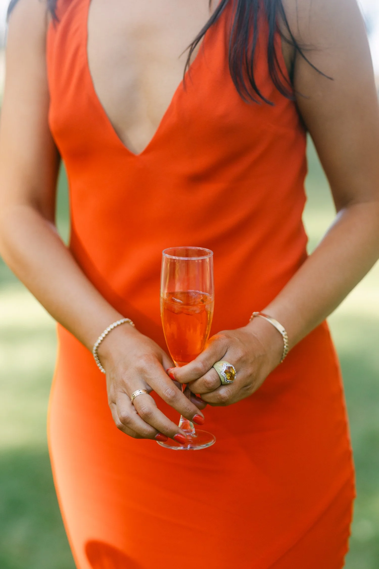Valhalla wedding photo of a guest in a vibrant dress with a cocktail