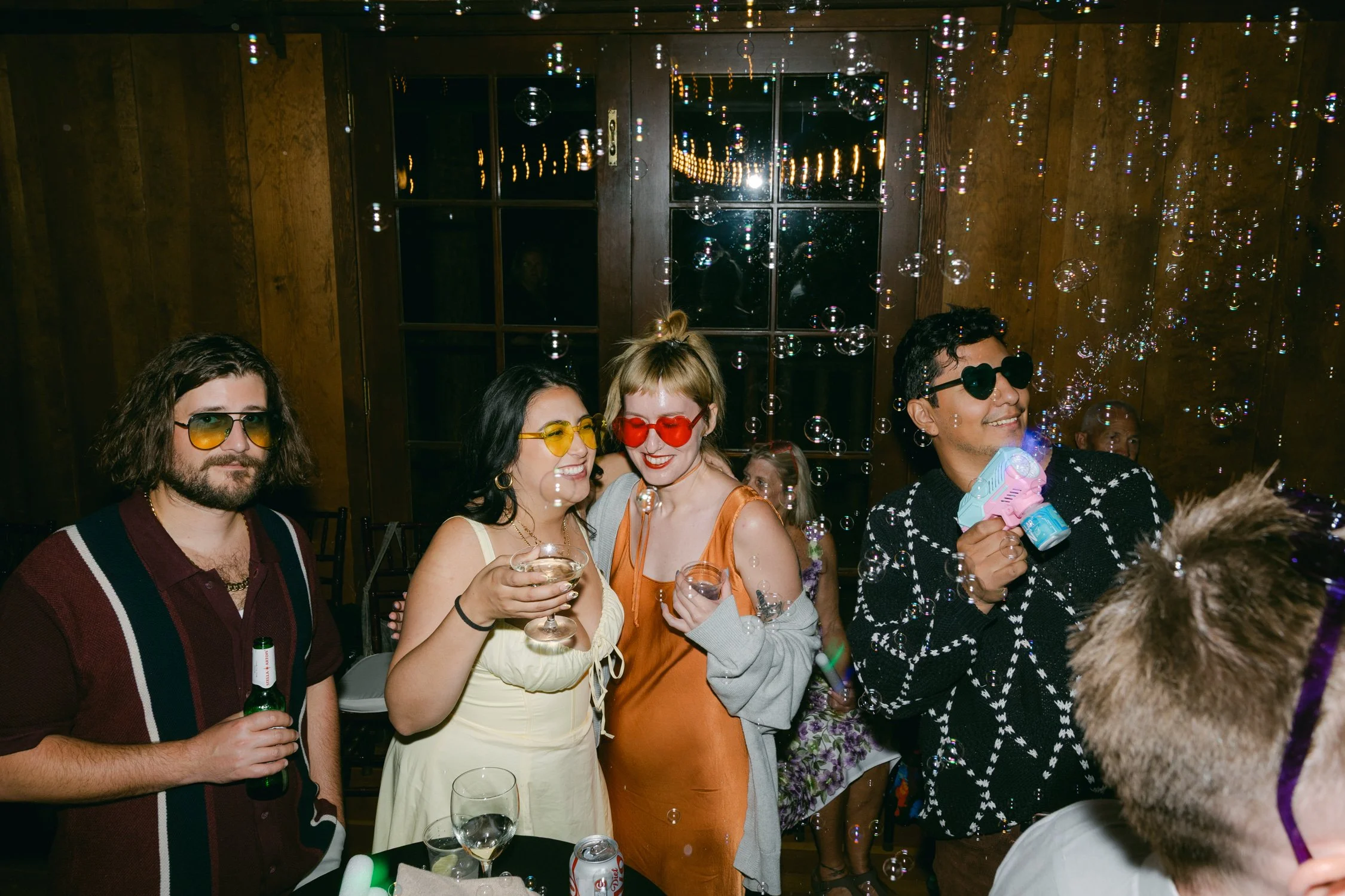 Valhalla wedding photo of guests playing with bubbles at night