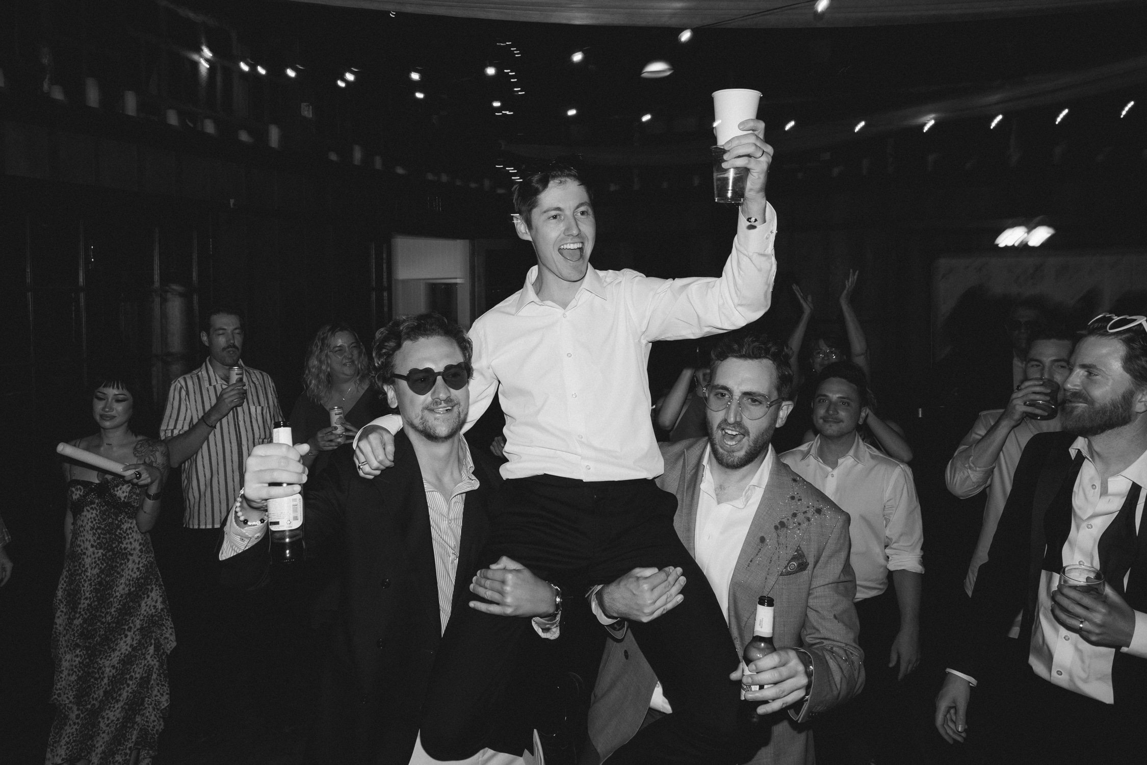 Valhalla wedding photo of the guests lifting the groom in celebration