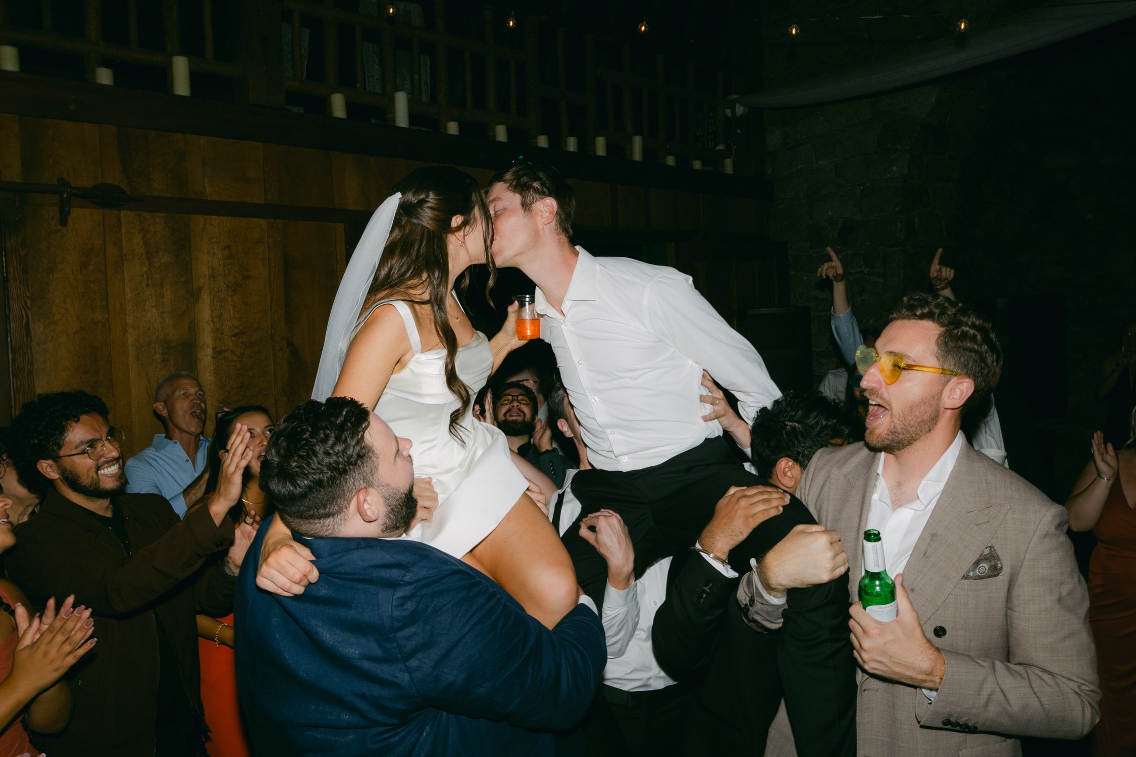 Valhalla wedding photo of the guests lifting the couple as they kiss