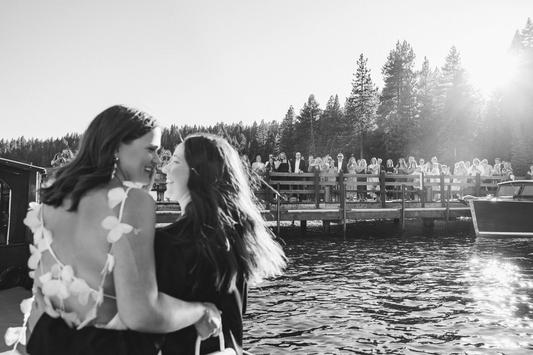 A Lake Tahoe summer wedding welcome party at garwoods, photo of the couple arriving by boat to meet family and friends