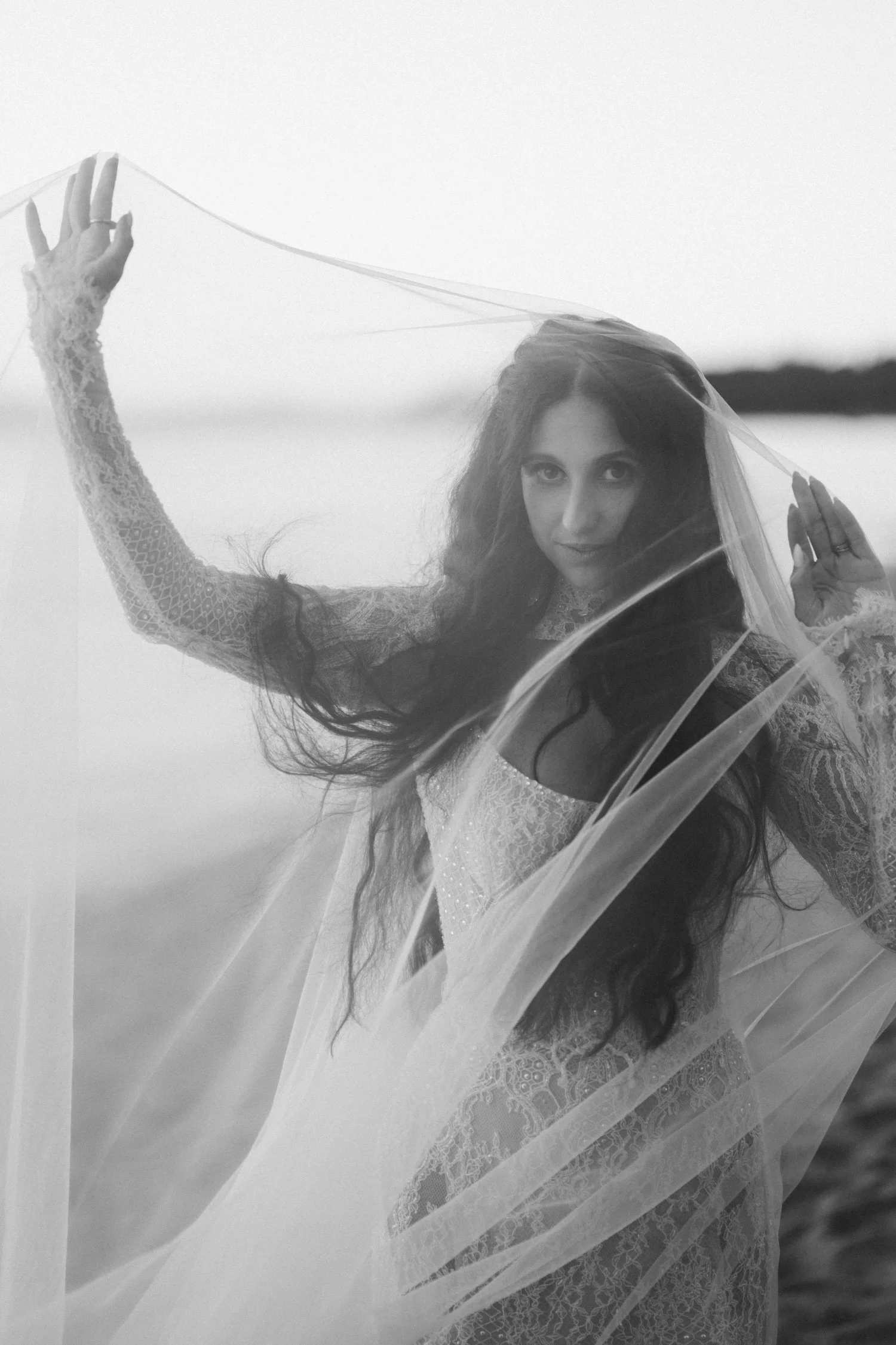 Edgewood Lake Tahoe wedding, photo of the bride standing by the lake with her flowing veil