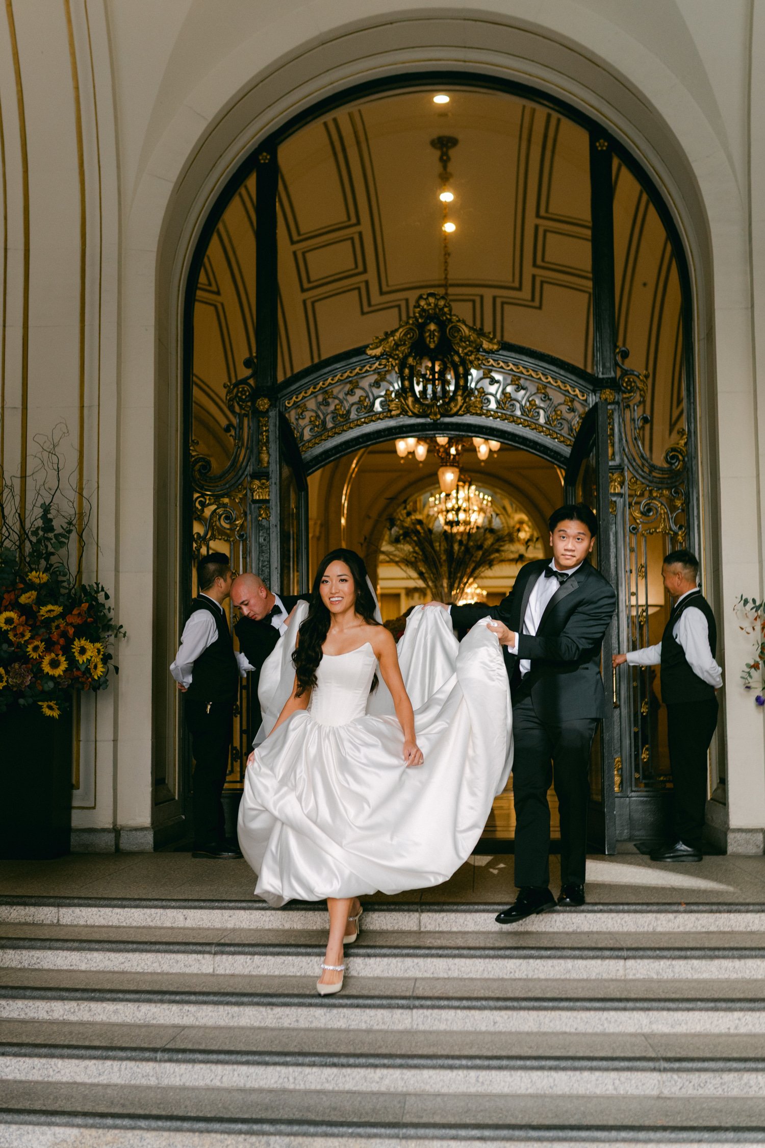 California Academy of Sciences in San Francisco Wedding, photo of the bride in her corset wedding dress walking down the stairs 
