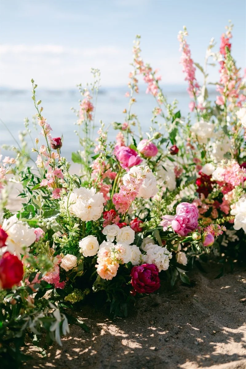 Beach Retreat &amp; Lodge at Tahoe wedding, photo of a beachside wedding ceremony featuring lush floral design