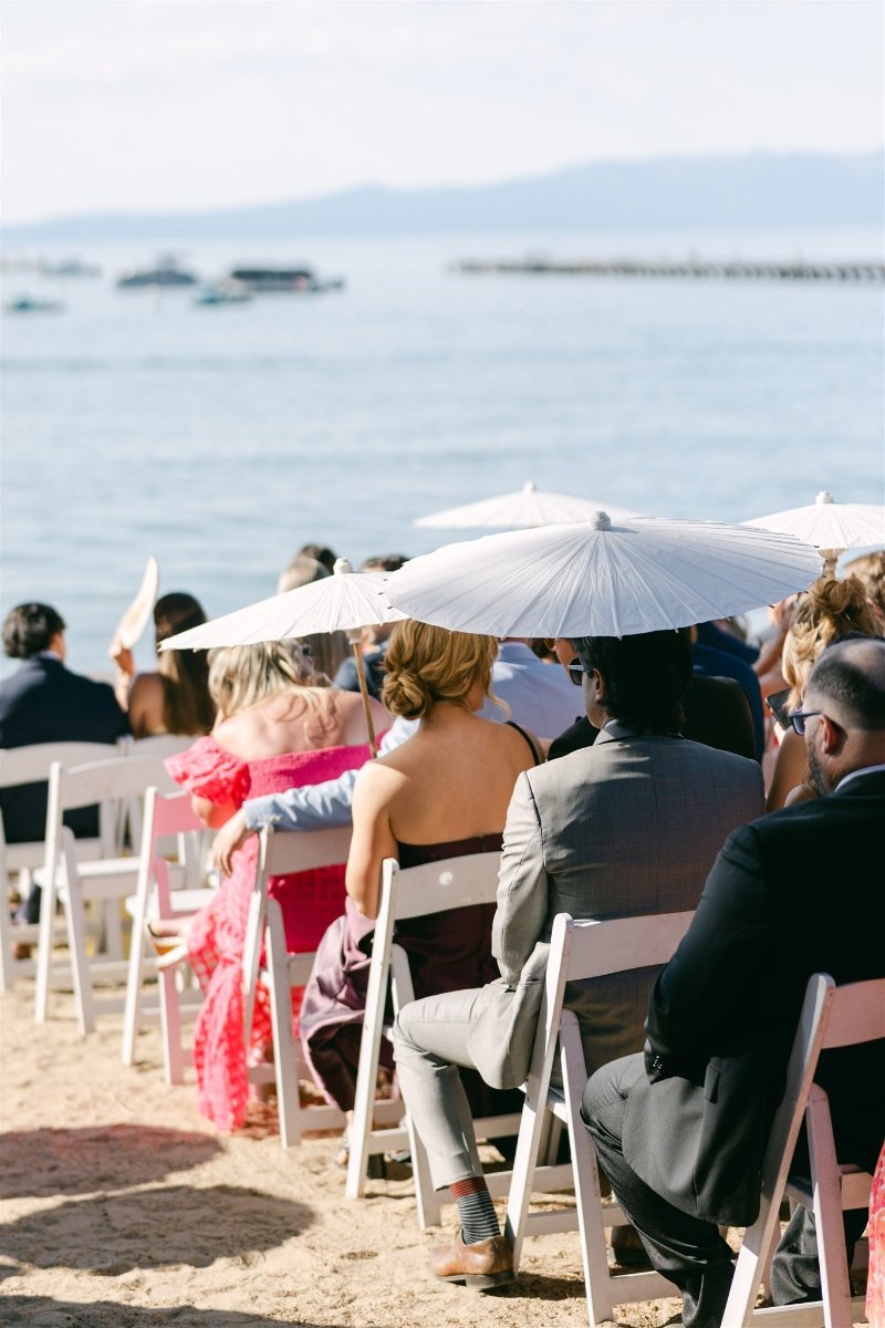 Beach Retreat &amp; Lodge at Tahoe wedding, photo of the beachside wedding ceremony with guests using parasol