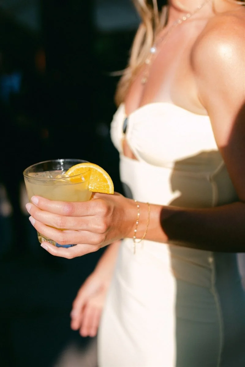 Beach Retreat &amp; Lodge at Tahoe wedding, photo of a wedding guest enjoying afternoon cocktails by the beach