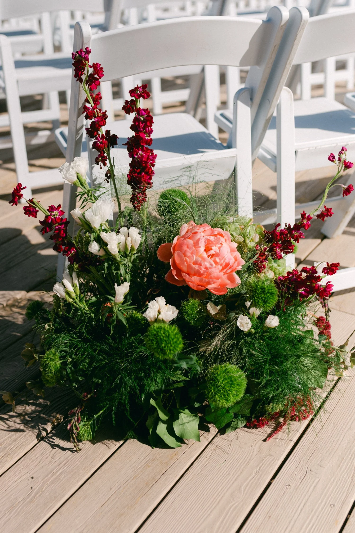 High Camp Ceremony, photo of vibrant floral arrangement designed as a wedding aisle marker. 