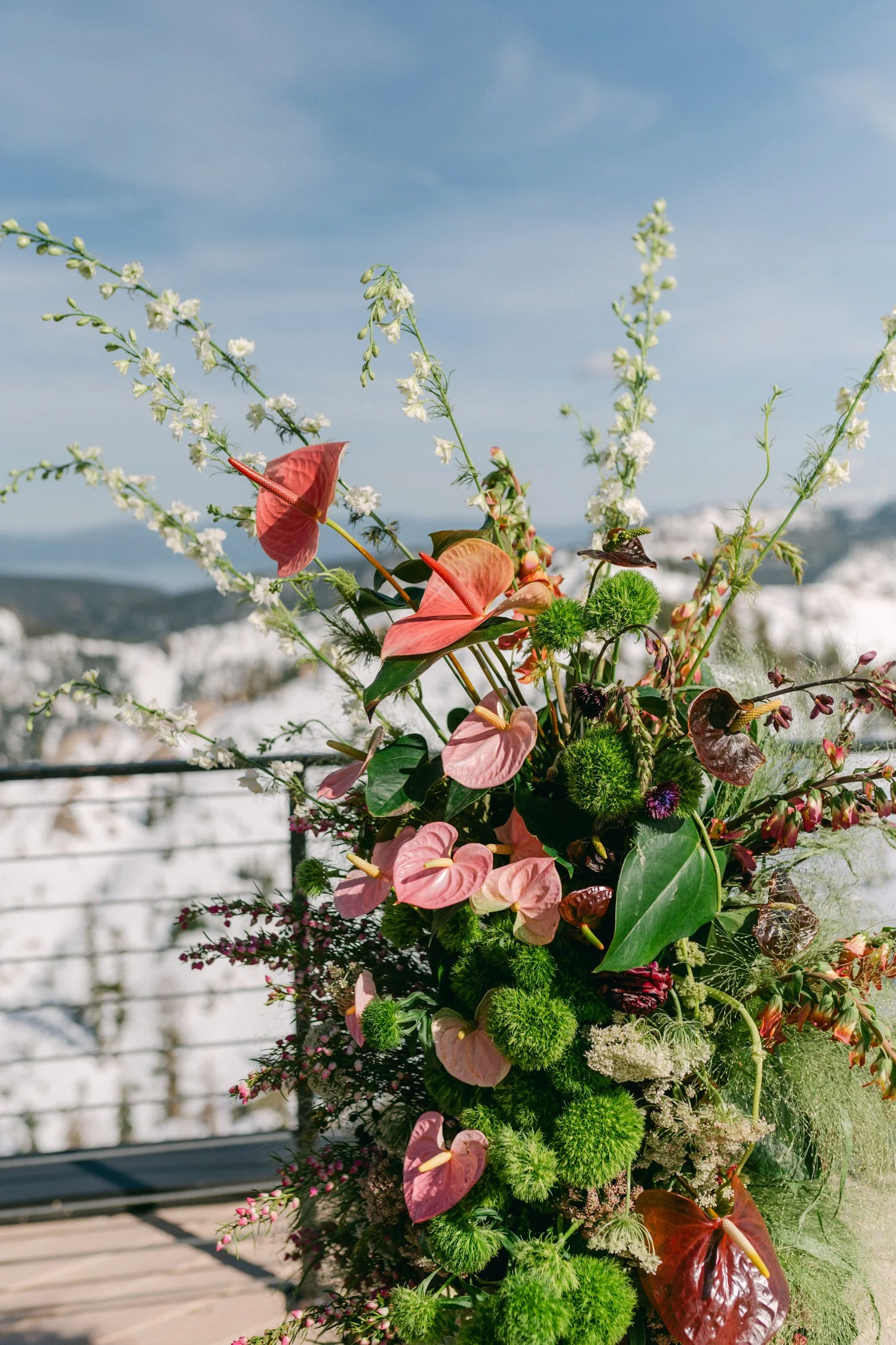 High Camp Ceremony, photo of vibrant floral arrangement designed for a wedding mountain-top ceremony, showcasing a blend of tropical and rustic elements. 