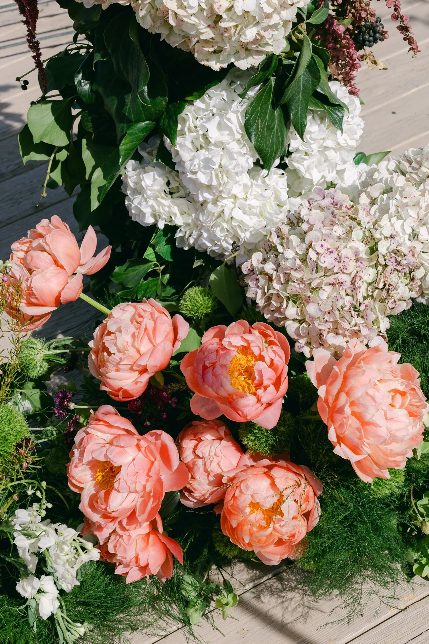 High Camp Ceremony, photo of the floral arrangements include vibrant colors like salmon, apricot, and white, inspired by wildflower meadows