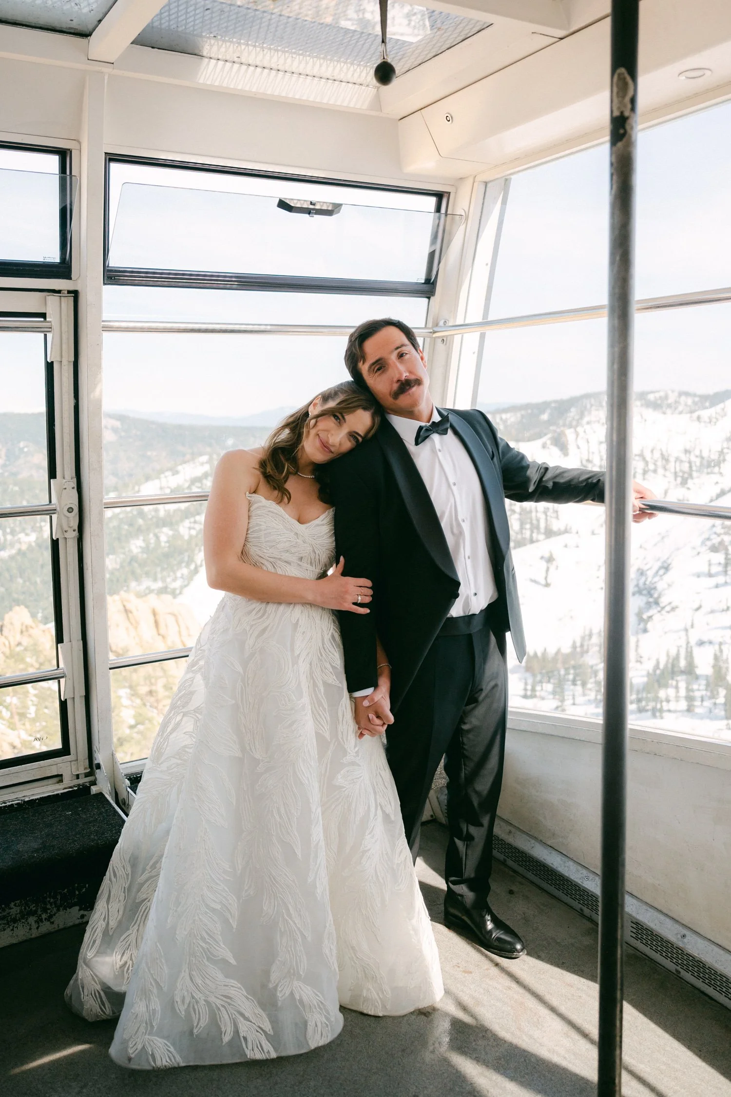 Palisades wedding venue, photo of the bride and groom inside a gondola cabin during a snowy mountain wedding. 