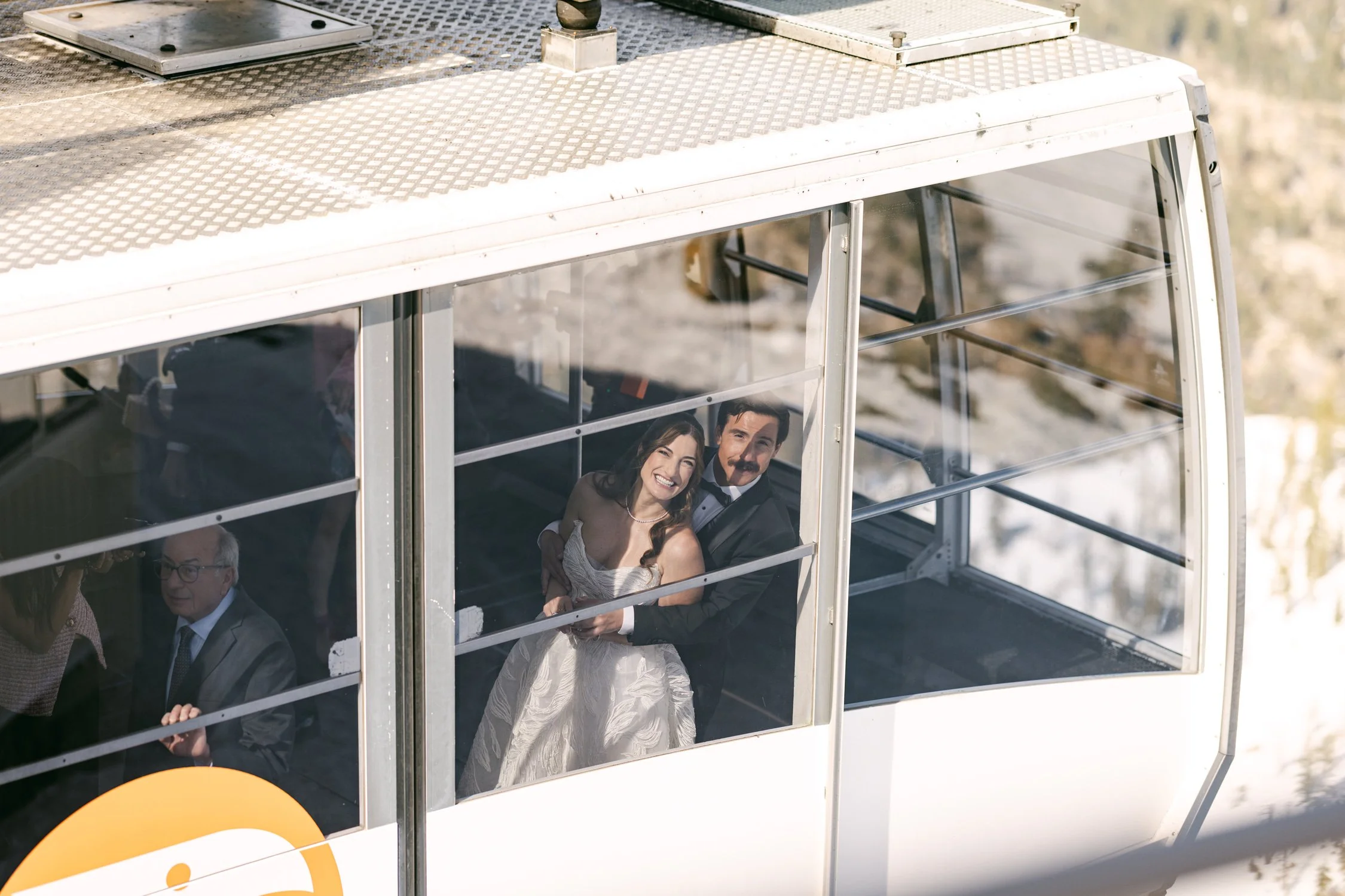 Palisades wedding venue, photo of the couple on their wedding day traveling in a gondola, at a mountain resort. 