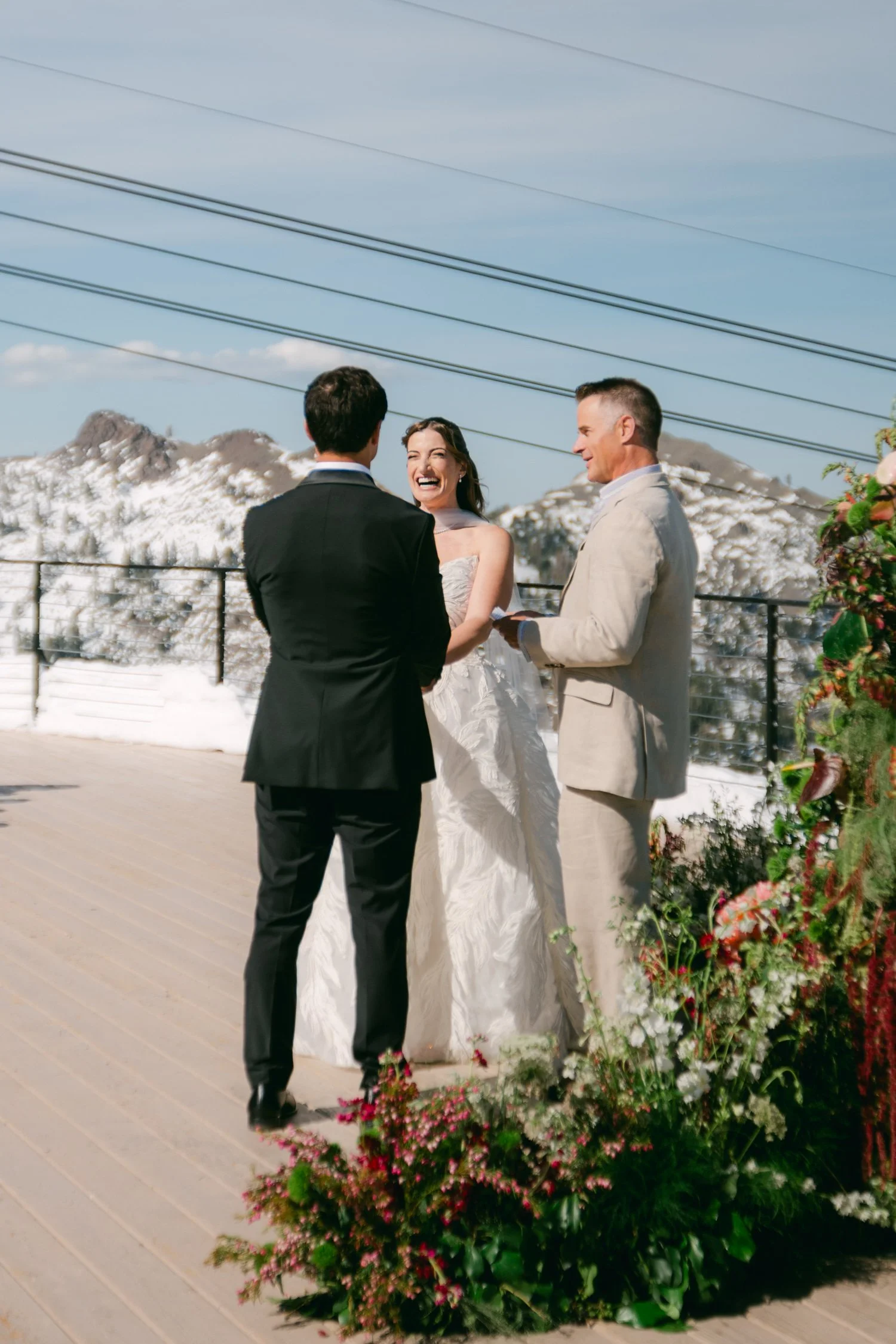 High Camp Ceremony, photo of a wedding ceremony taking place on a sunny deck overlooking snowy mountains. 