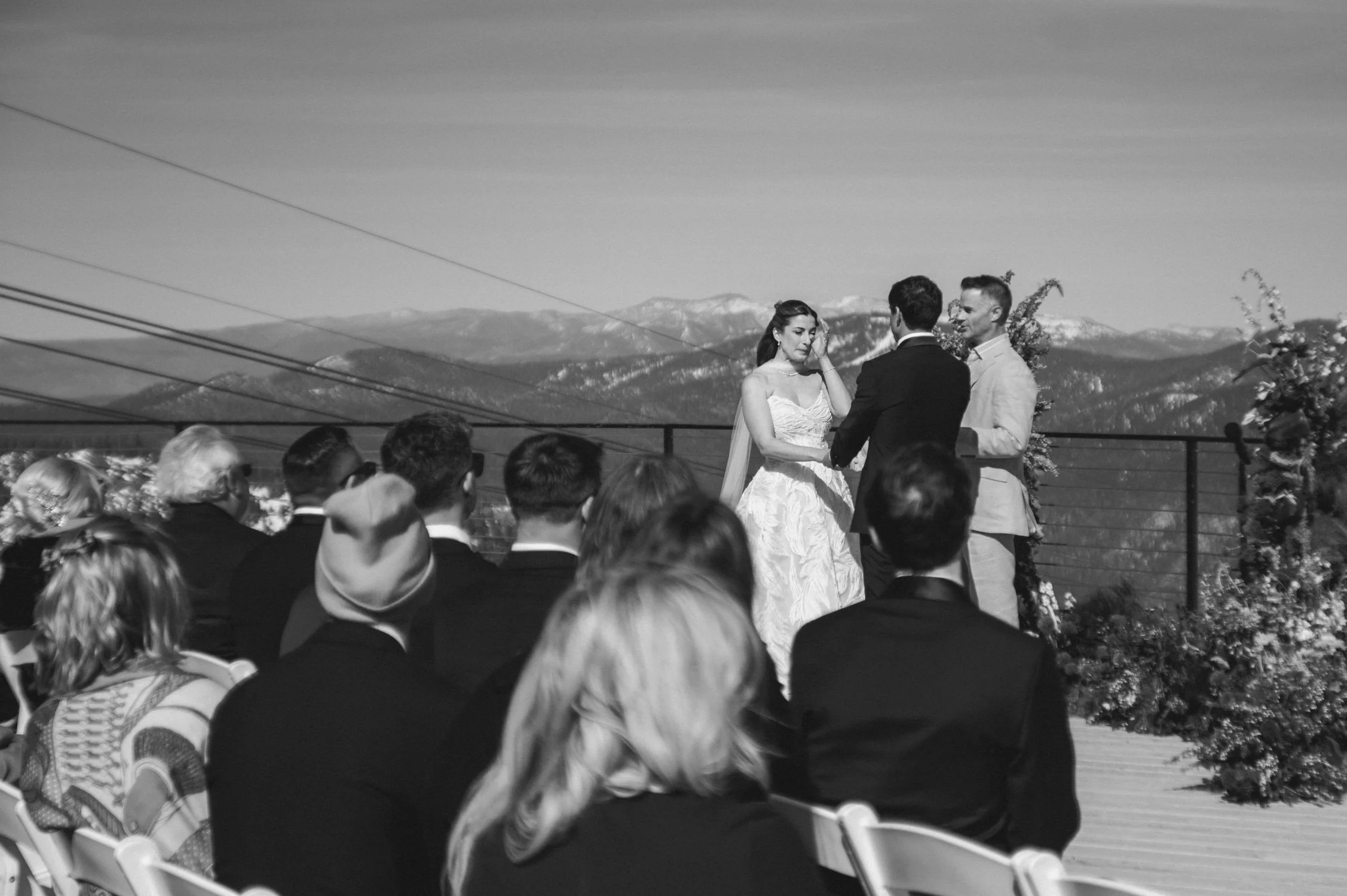 High Camp Ceremony, photo of intimate outdoor wedding ceremony taking place on a modern wooden deck with a breathtaking panoramic view of the mountains. 