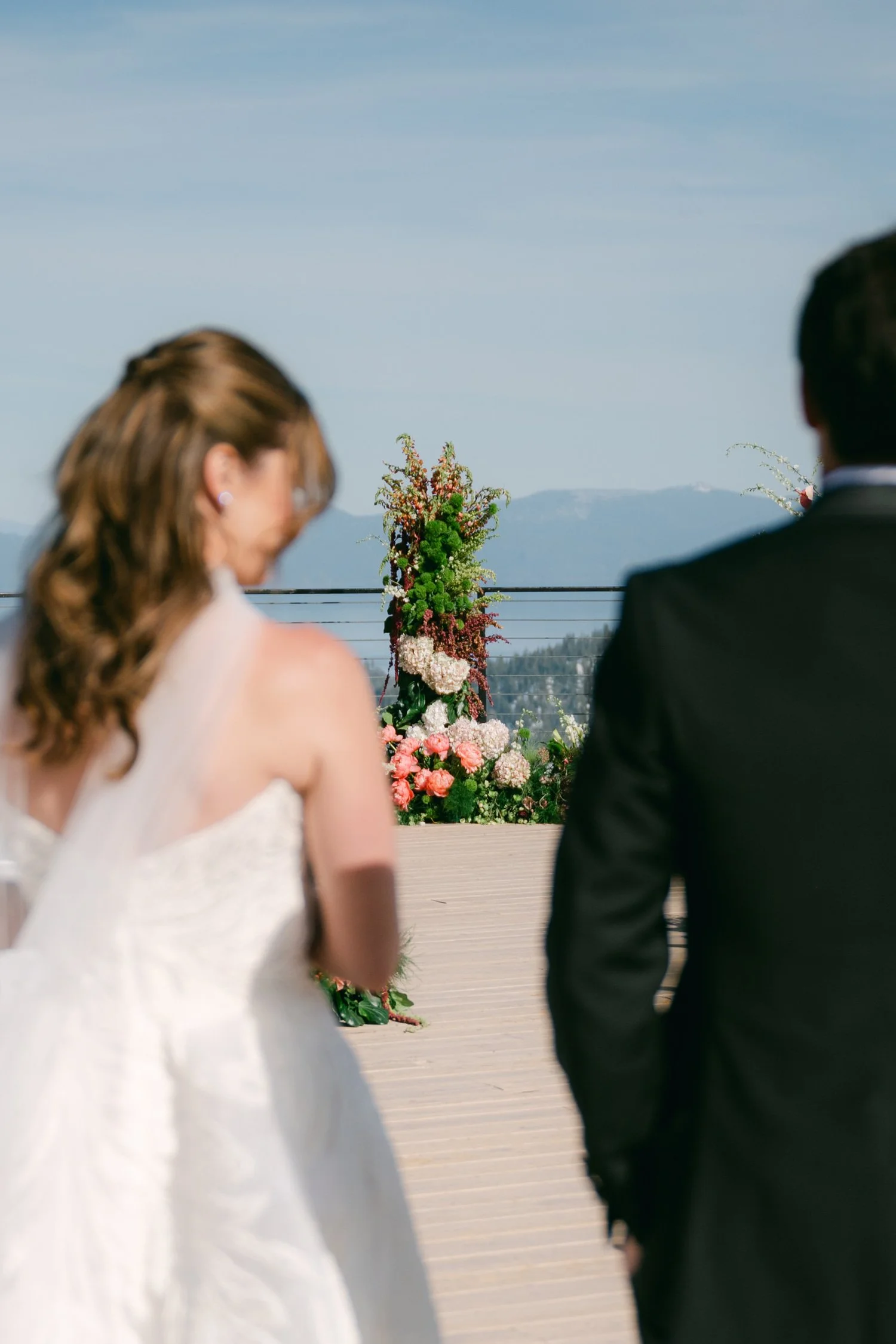 Palisades wedding venue, photo of the wedding ceremony taking place on an outdoor deck overlooking a scenic mountain range. 
