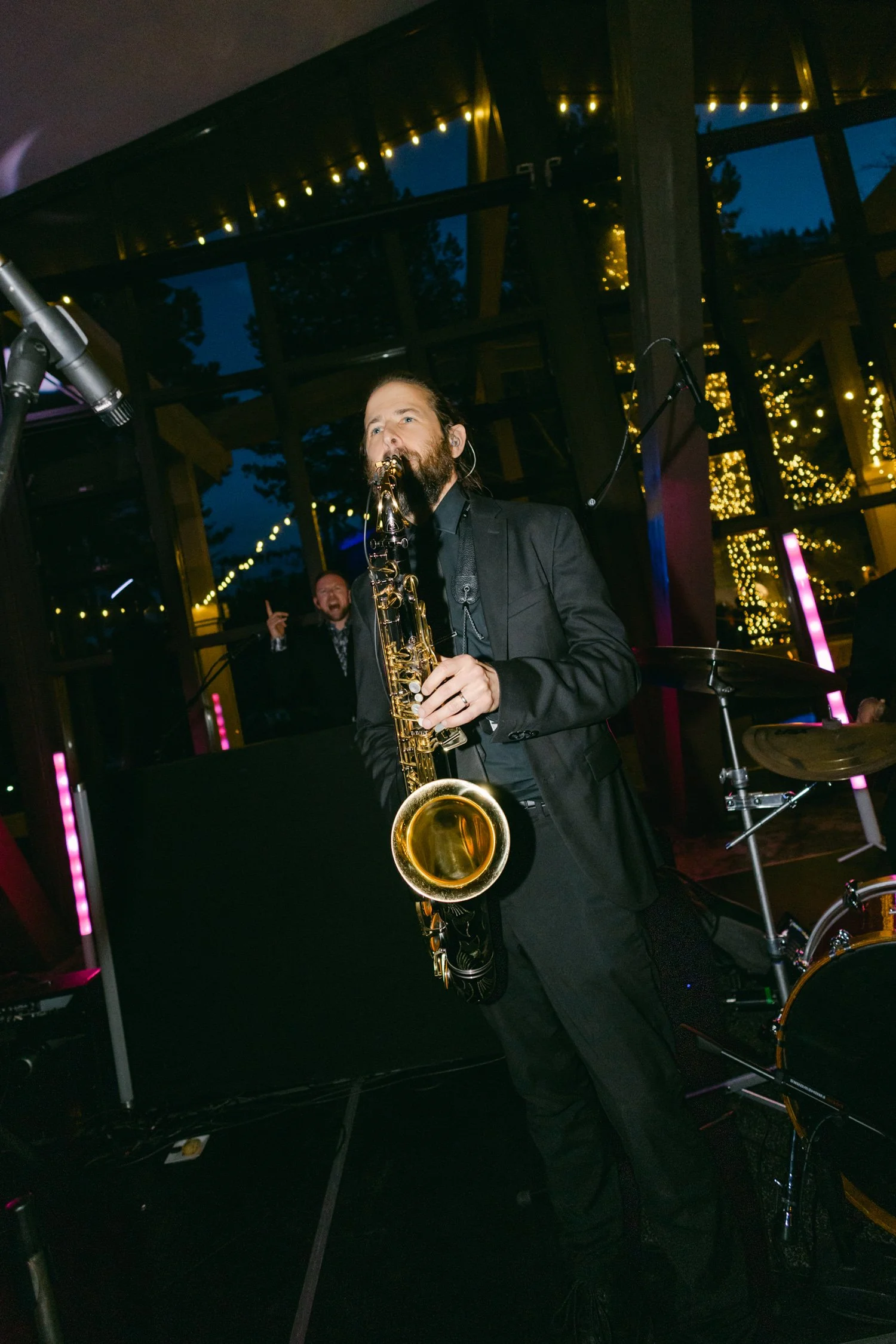 Palisades wedding venue, photo of a live performance, featuring a musician playing a saxophone during the reception