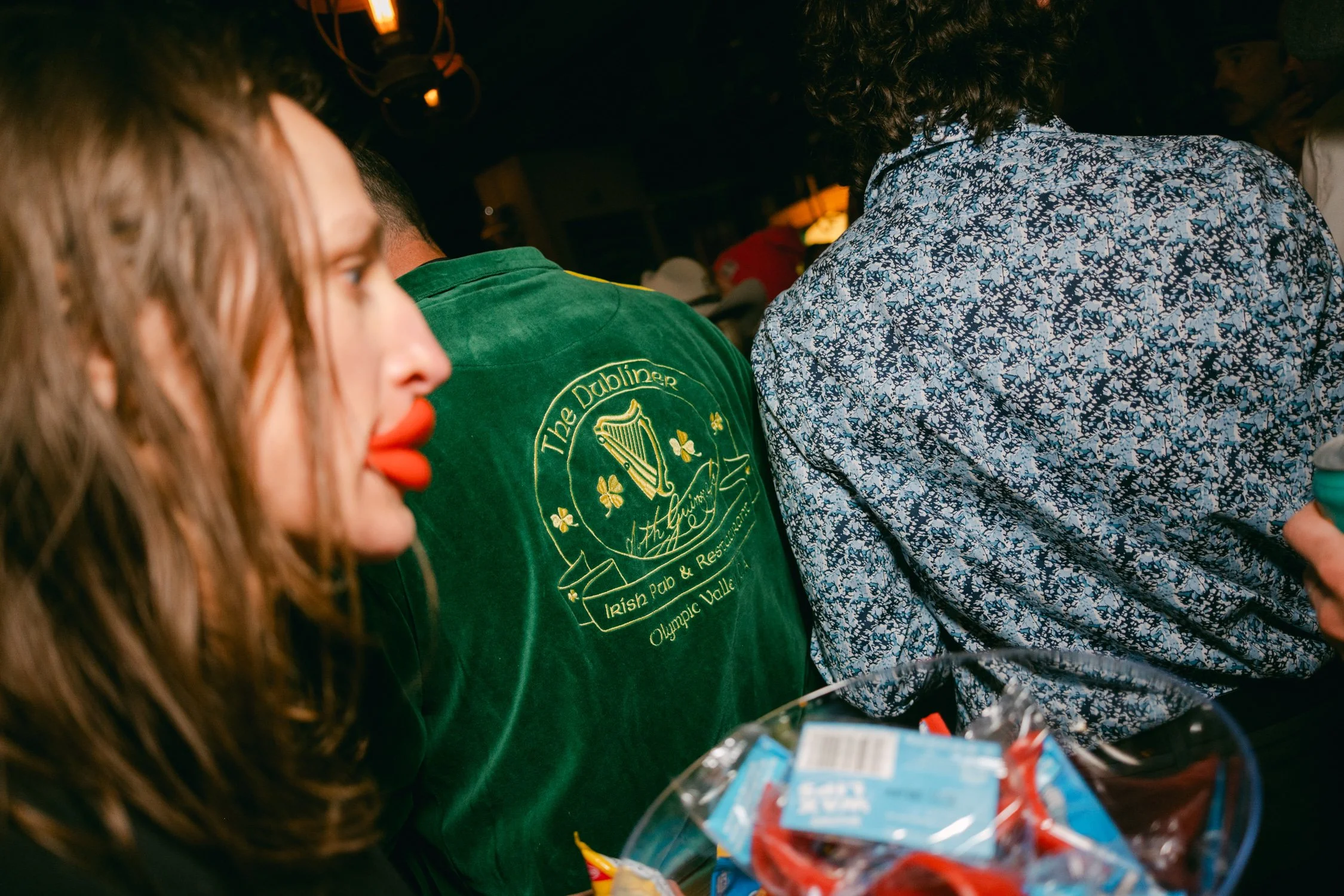 Palisades wedding venue, photo of afterparty celebration with guests wearing themed items such as green clothing and large decorative lips.