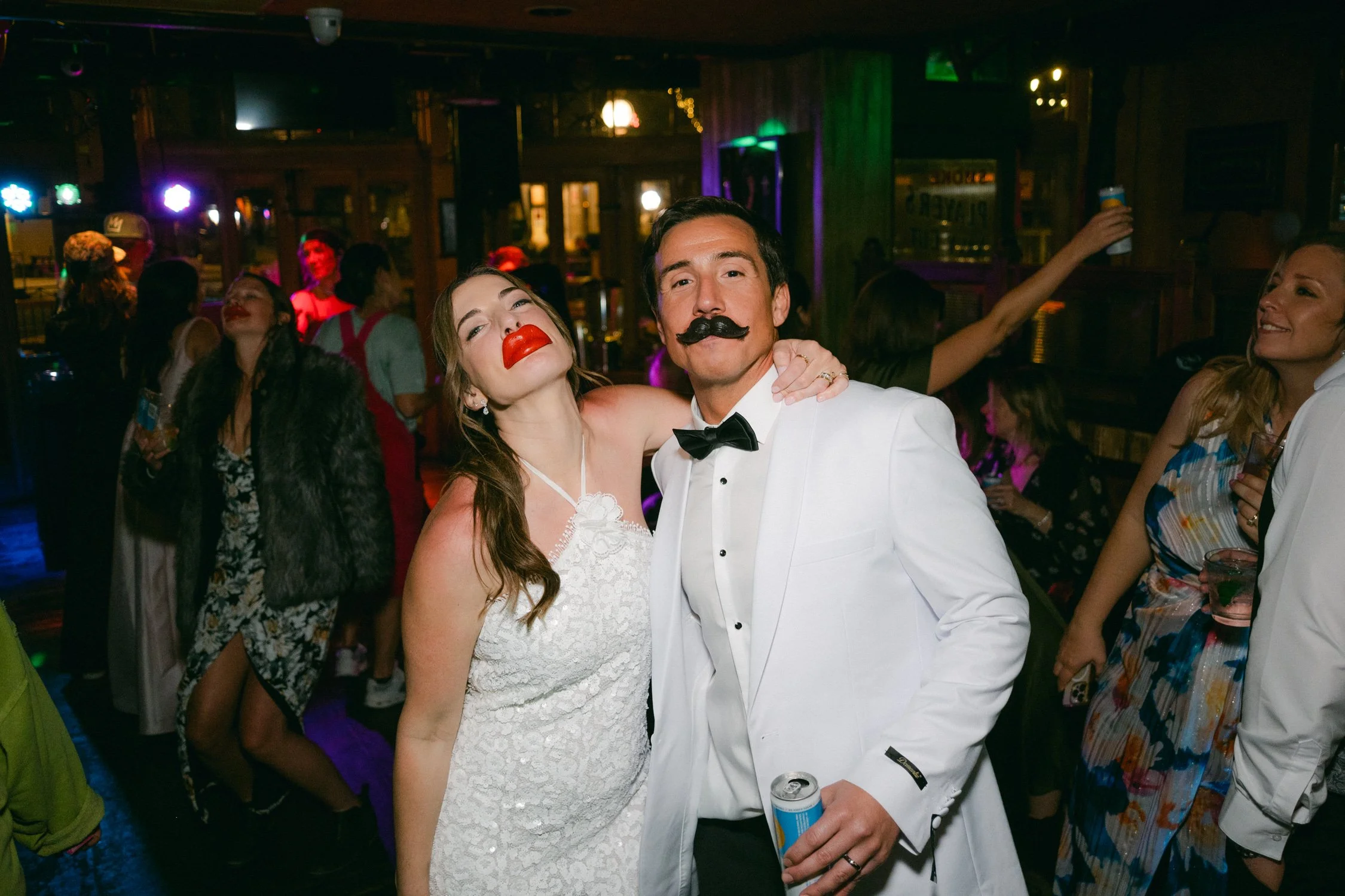 Palisades wedding venue, photo of the couple is wearing playful props in their afterparty