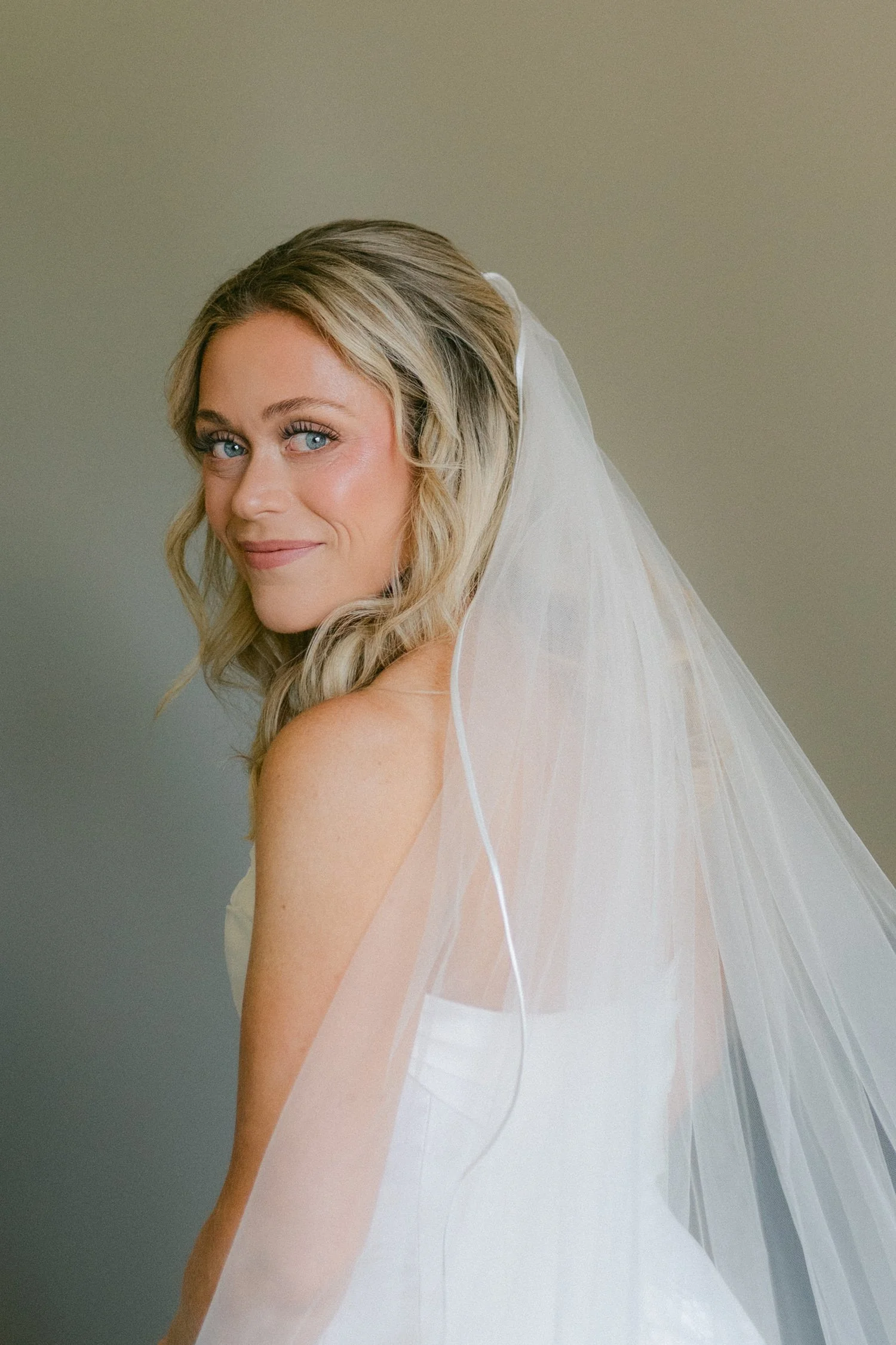 Edgewood maximalist wedding, photo of a traditional bride with a satin trim wedding veil 