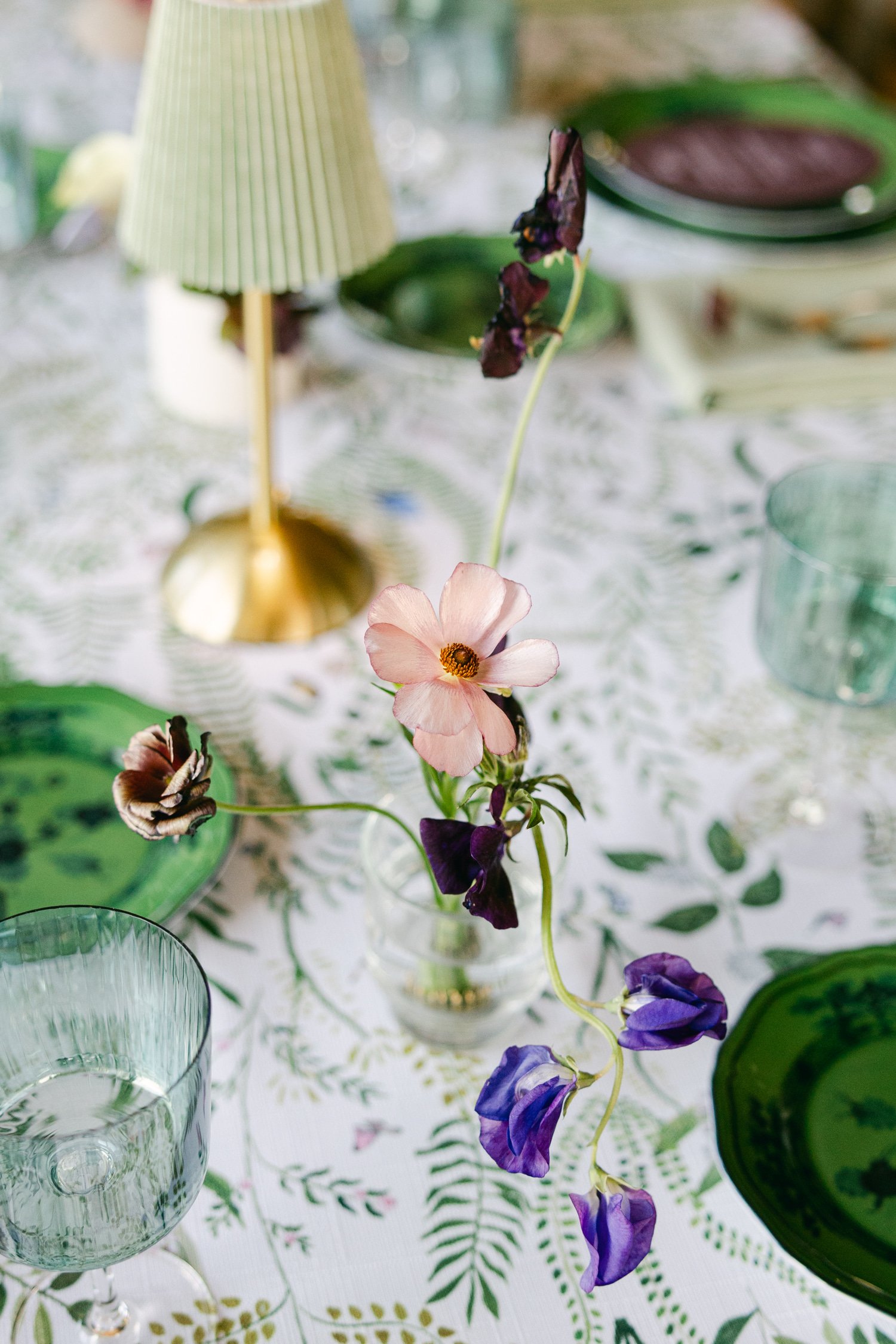 Edgewood maximalist wedding, photo of an elegant tablescape featuring soft pastel flowers, and sage-colored glassware 