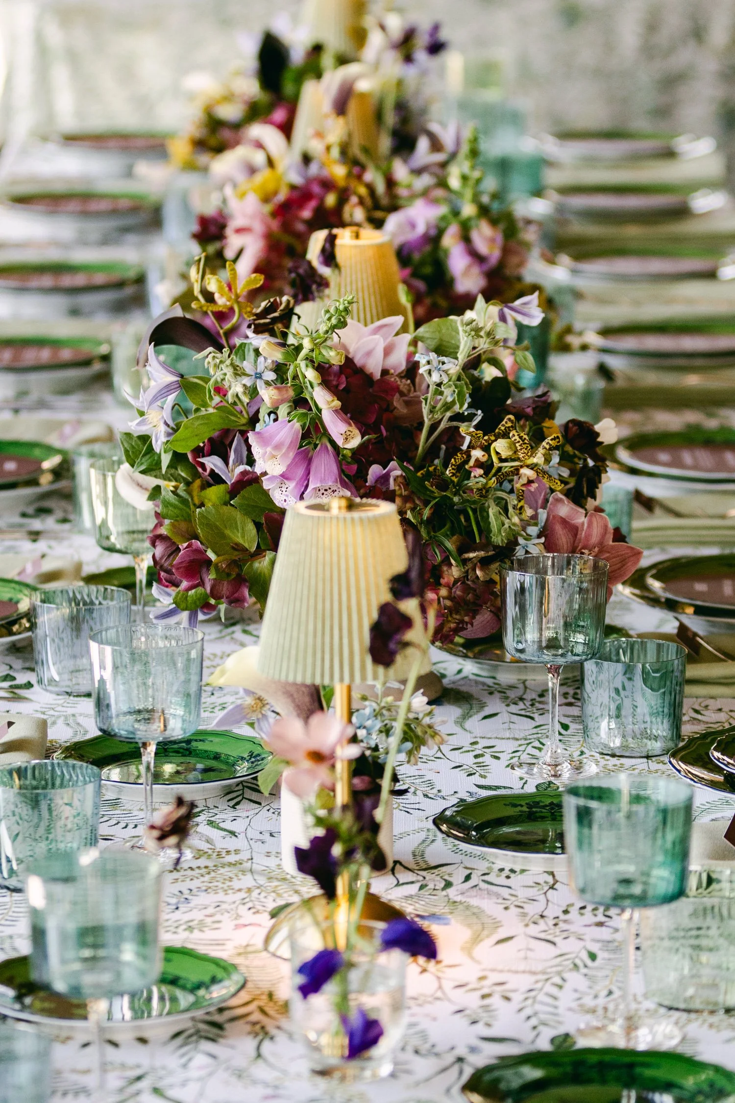 Edgewood maximalist wedding, photo of whimsical garden wedding tablescape featuring intricate floral arrangements and delicate table lamps