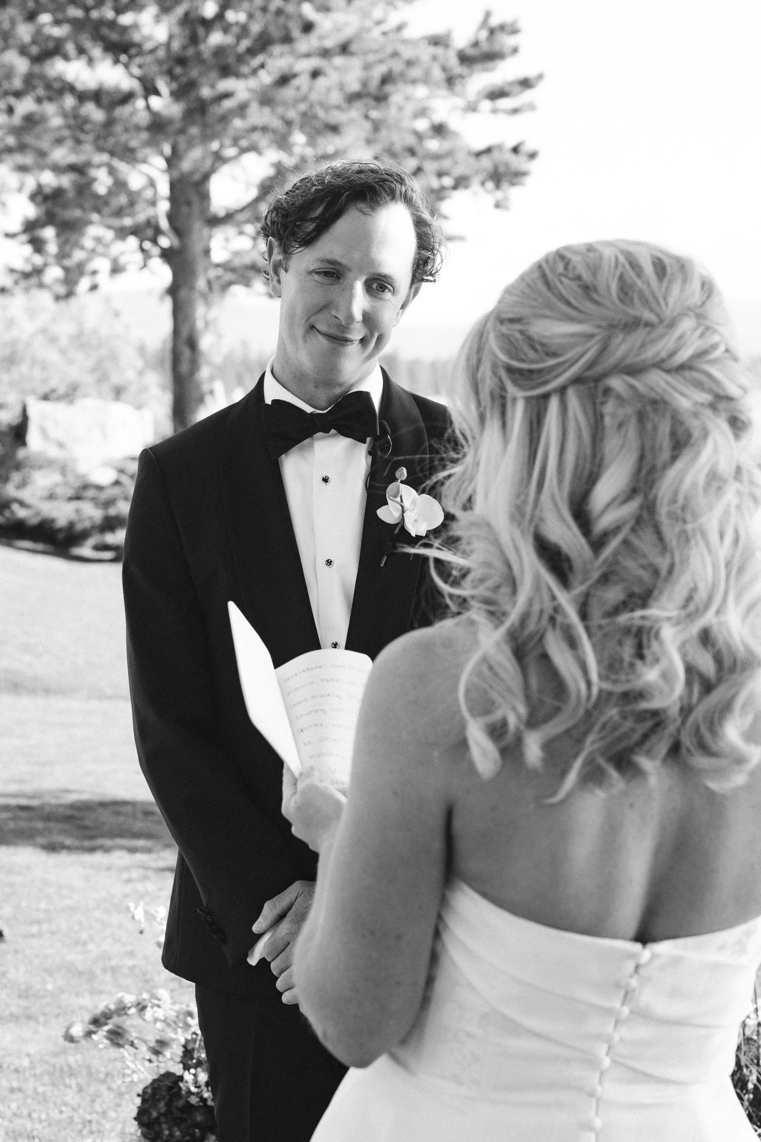 Edgewood maximalist wedding, photo of a heartfelt moment between the bride and groom exchanging vows capturing the emotion of the ceremony.