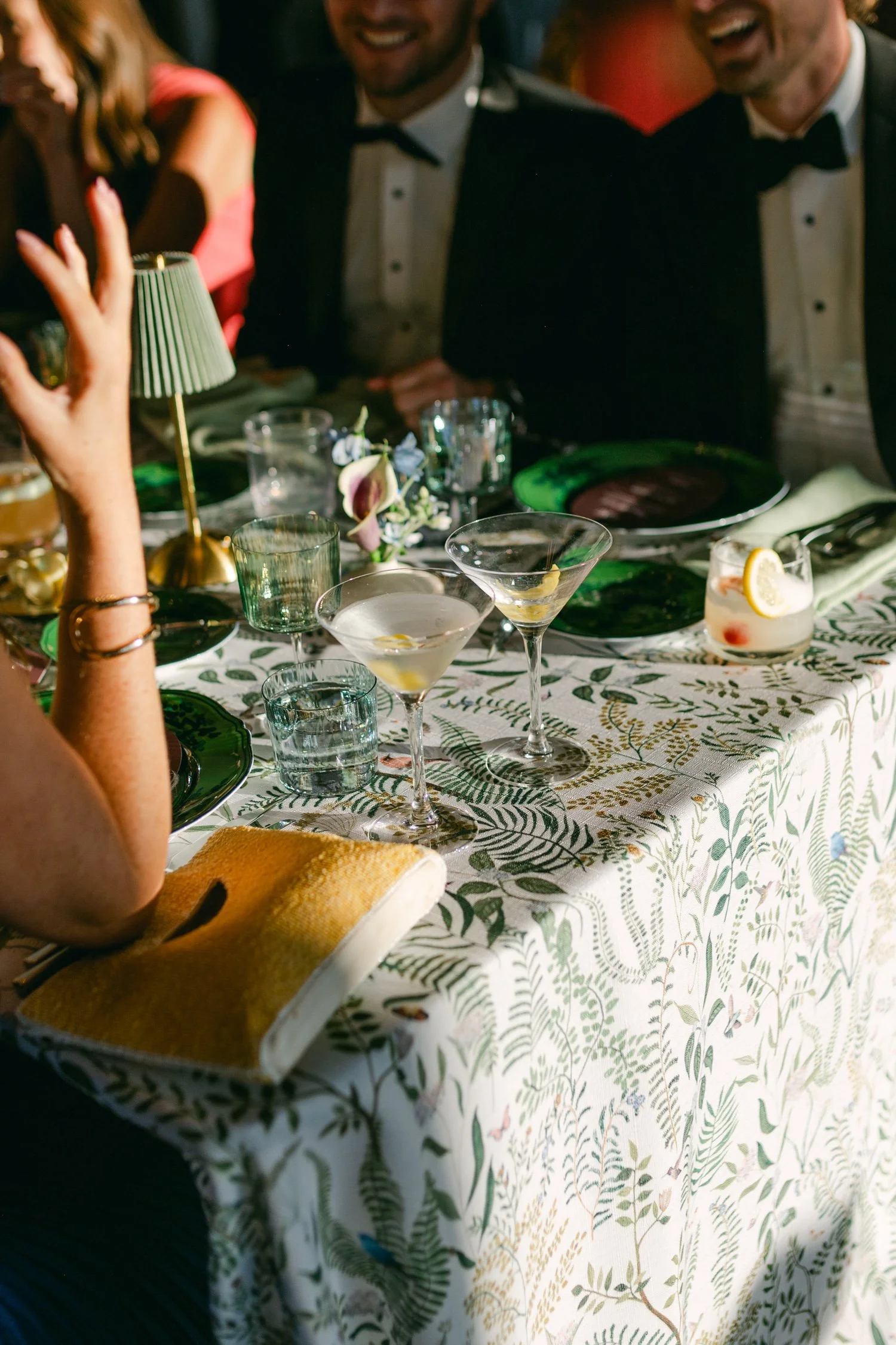 Edgewood maximalist wedding, photo of vibrant wedding tablescape featuring table linen decorated with a lush, green tropical pattern