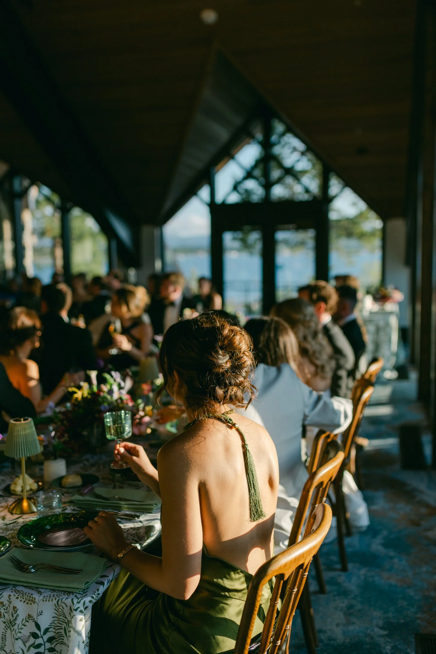 Edgewood maximalist wedding, photo of the wedding guest in a green slip dress with a delicate tassel detail on the back