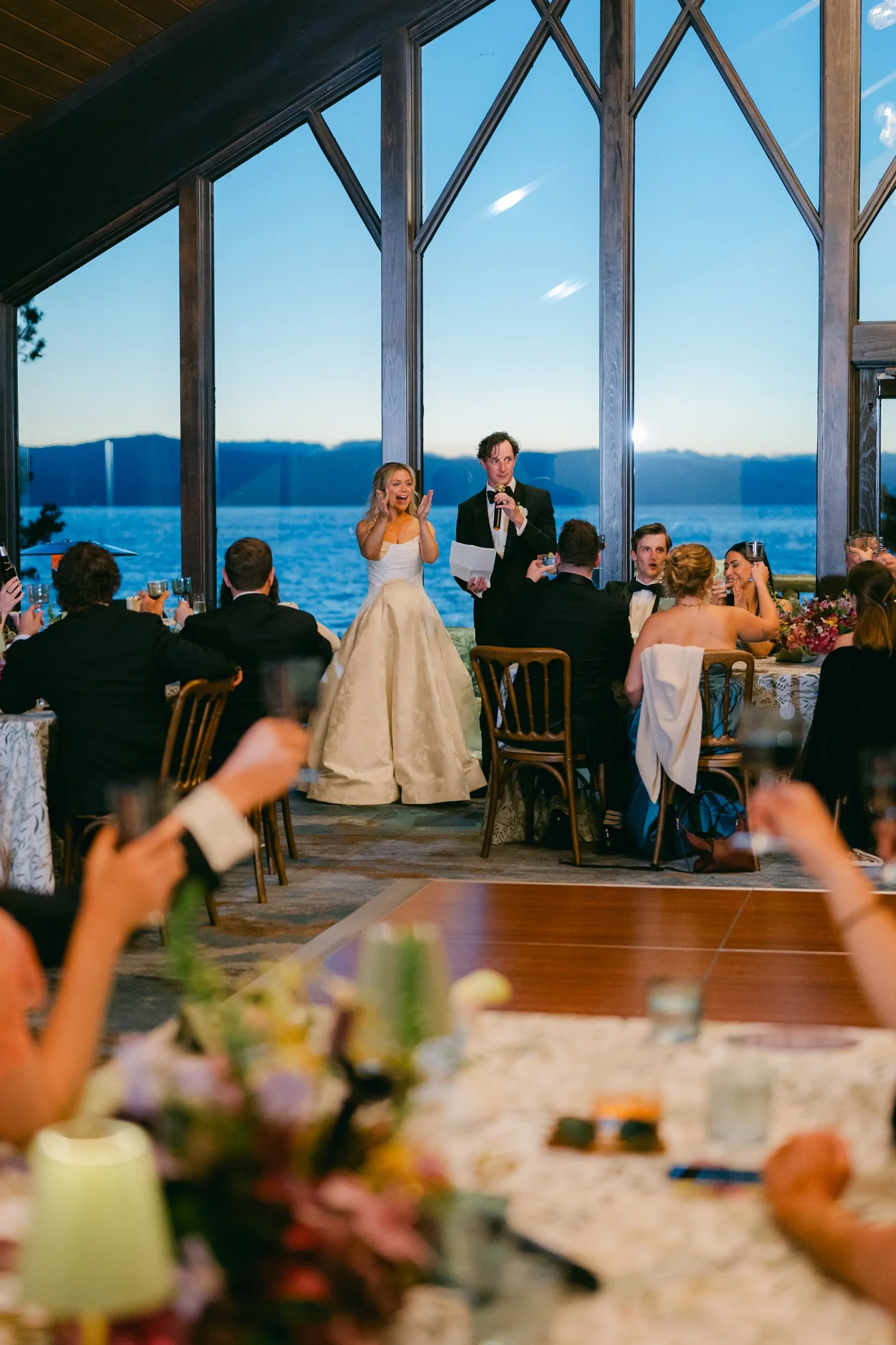 Edgewood maximalist wedding, photo of the bride and groom giving heartfelt speeches in a breathtaking floor-to-ceiling window views of Lake Tahoe