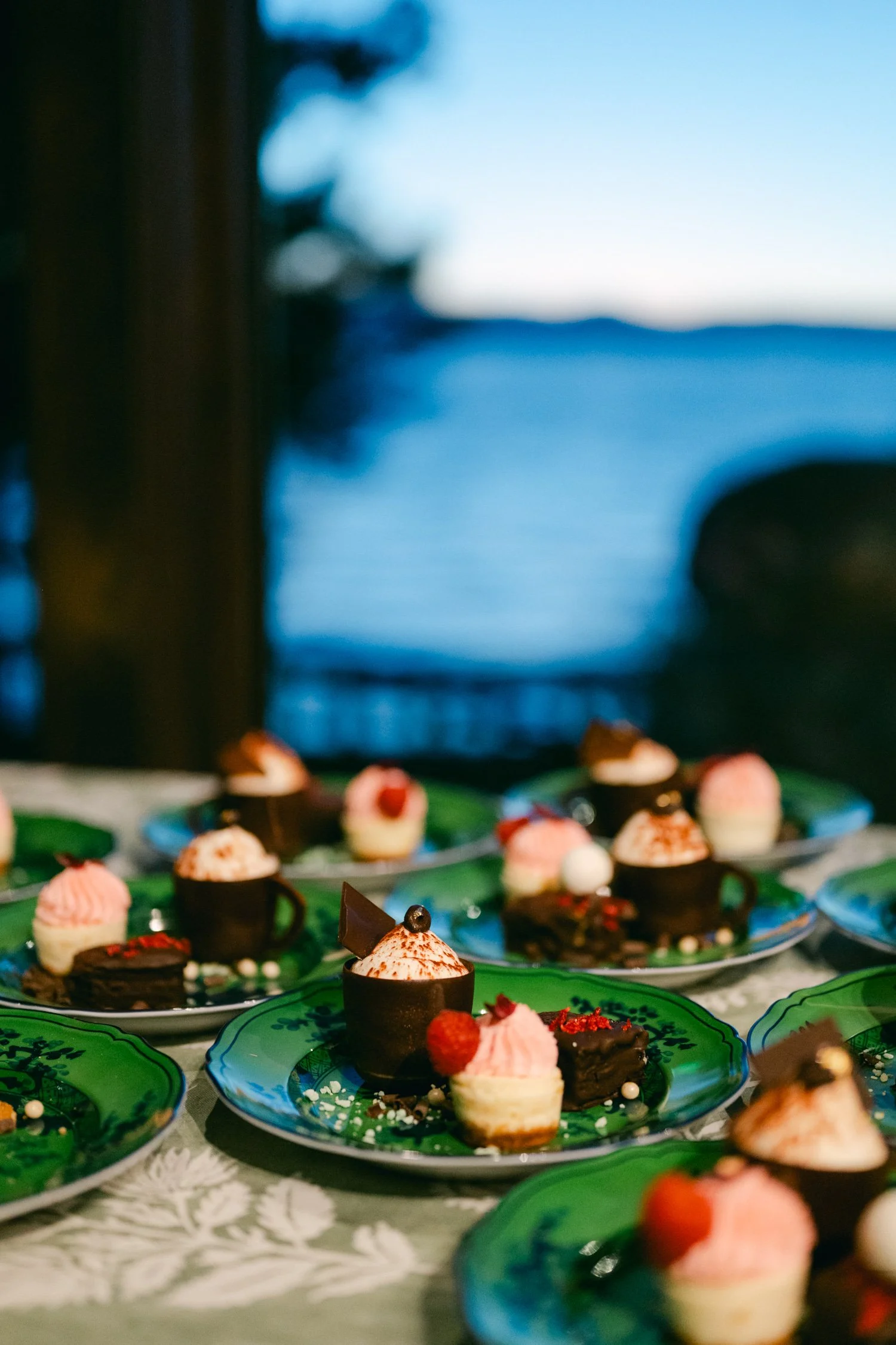 Edgewood maximalist wedding, photo of curated dessert buffet arranged on green patterned ceramic plates.