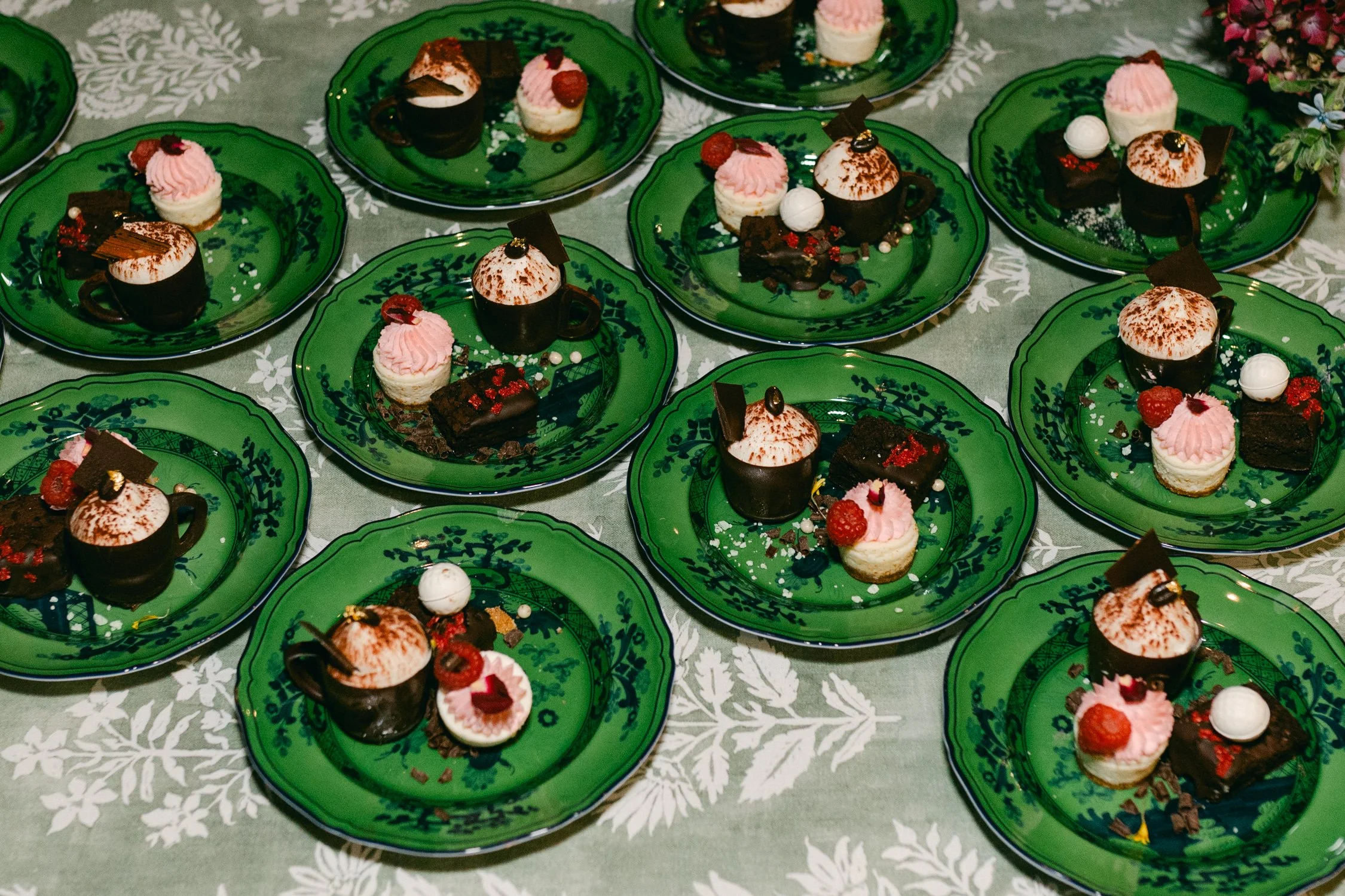 Edgewood maximalist wedding, photo of dessert buffet served on green, vintage-style ceramic plates 