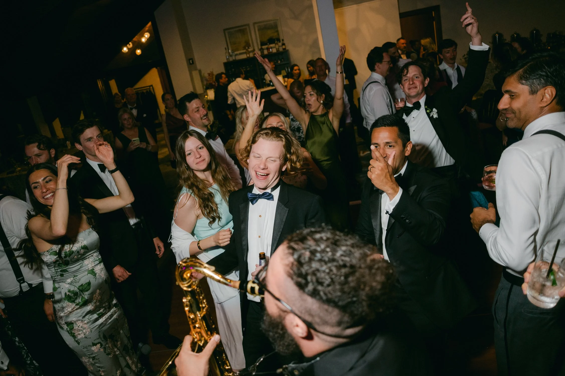 Edgewood maximalist wedding, photo of a lively wedding reception featuring guests dancing and celebrating