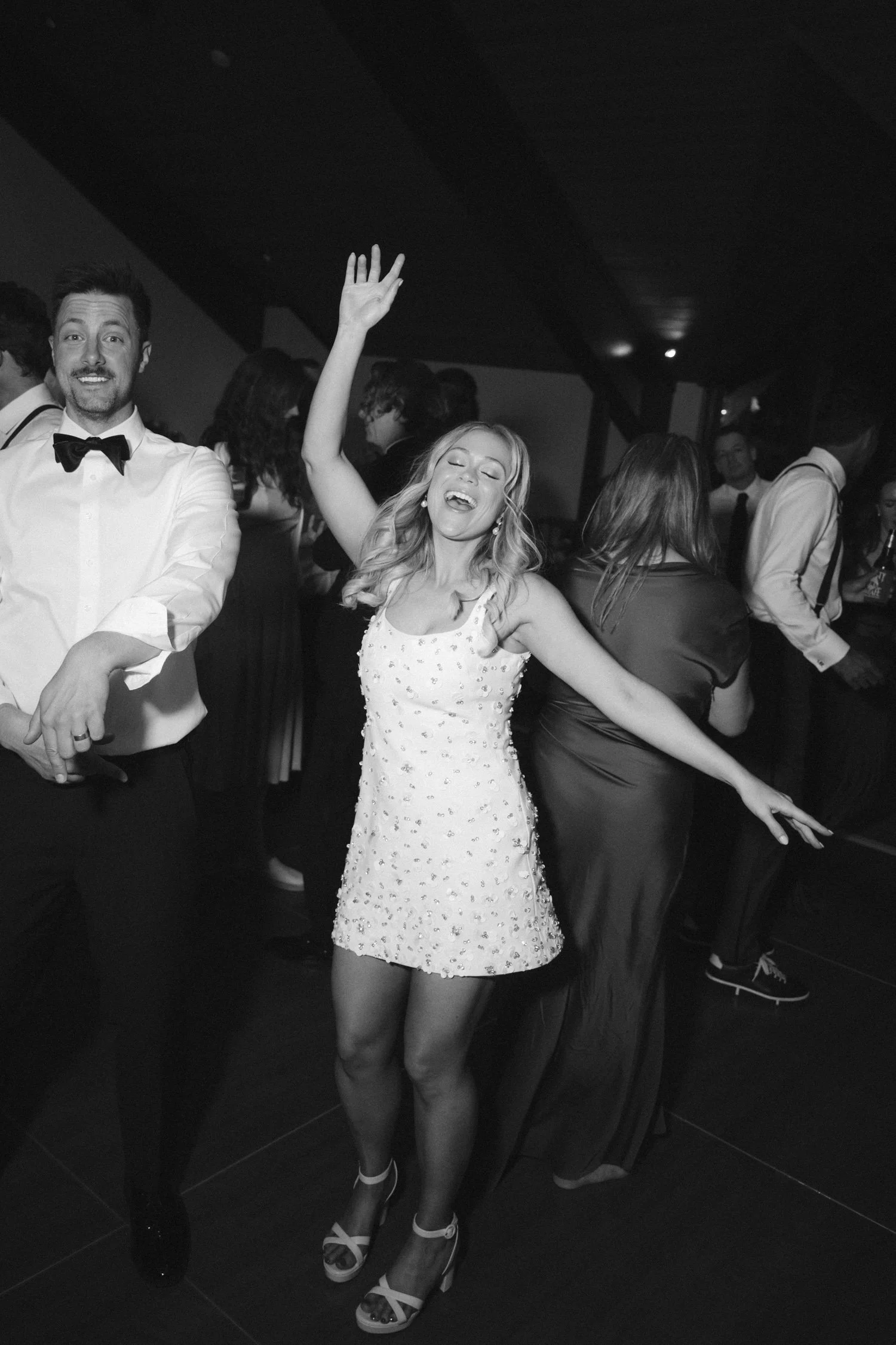 Edgewood maximalist wedding, photo of the bride enjoying the reception in her white sequin-embellished mini dress