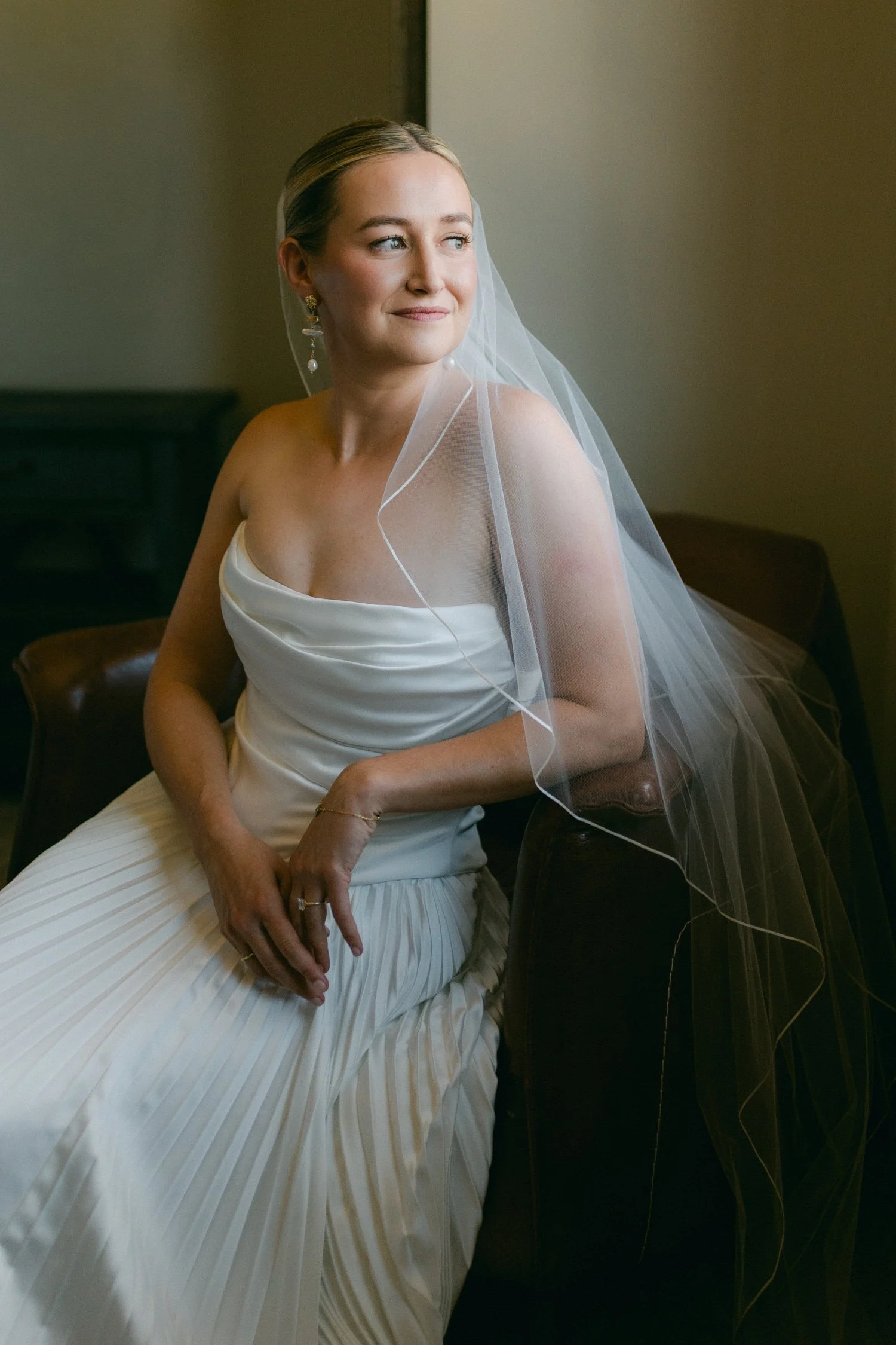 Lake Tahoe 4-H Camp wedding photos, photo of the bride in a strapless wedding gown with a pleated skirt and a sheer veil